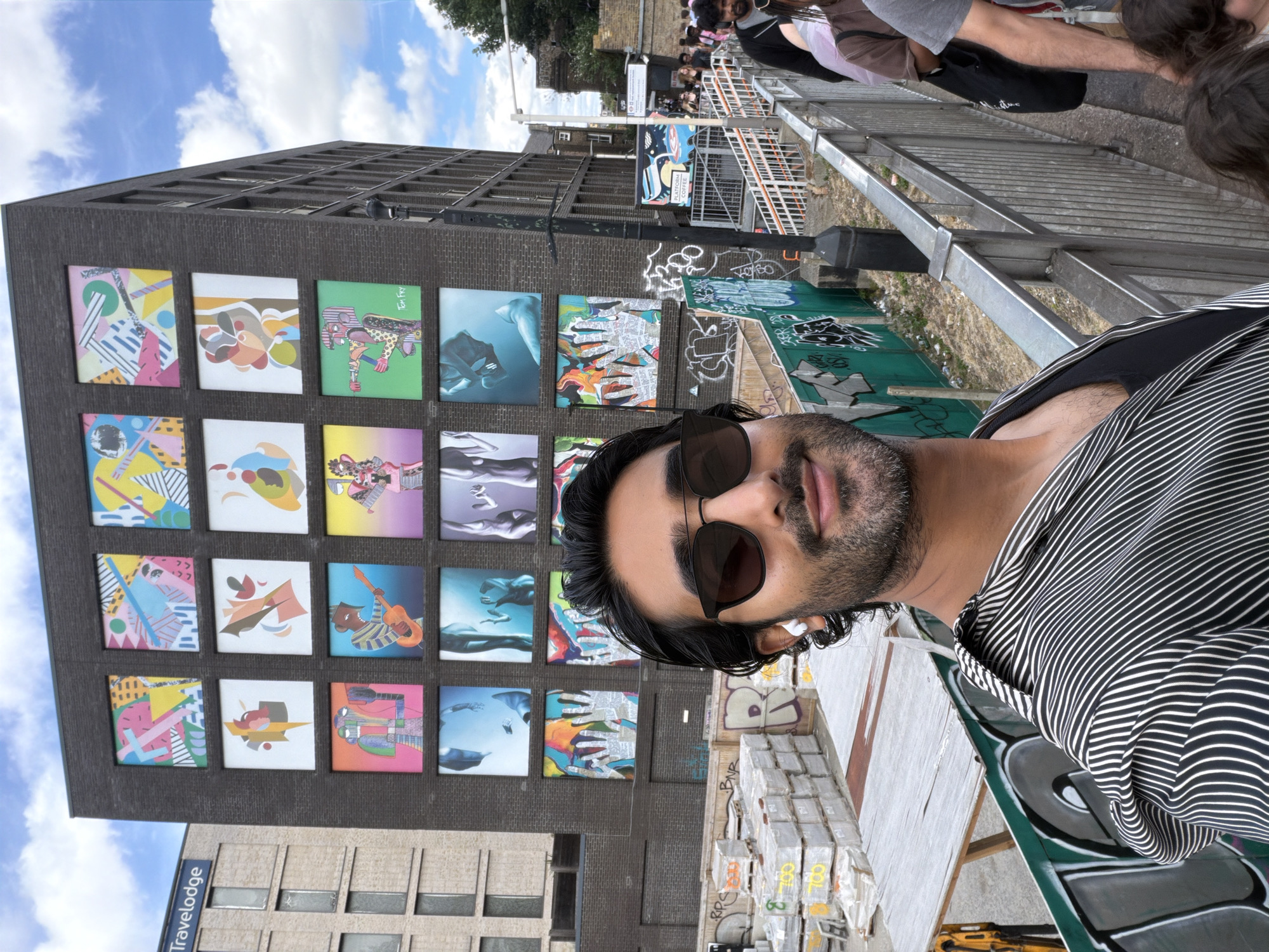 Street activity around a colorful mural building in London