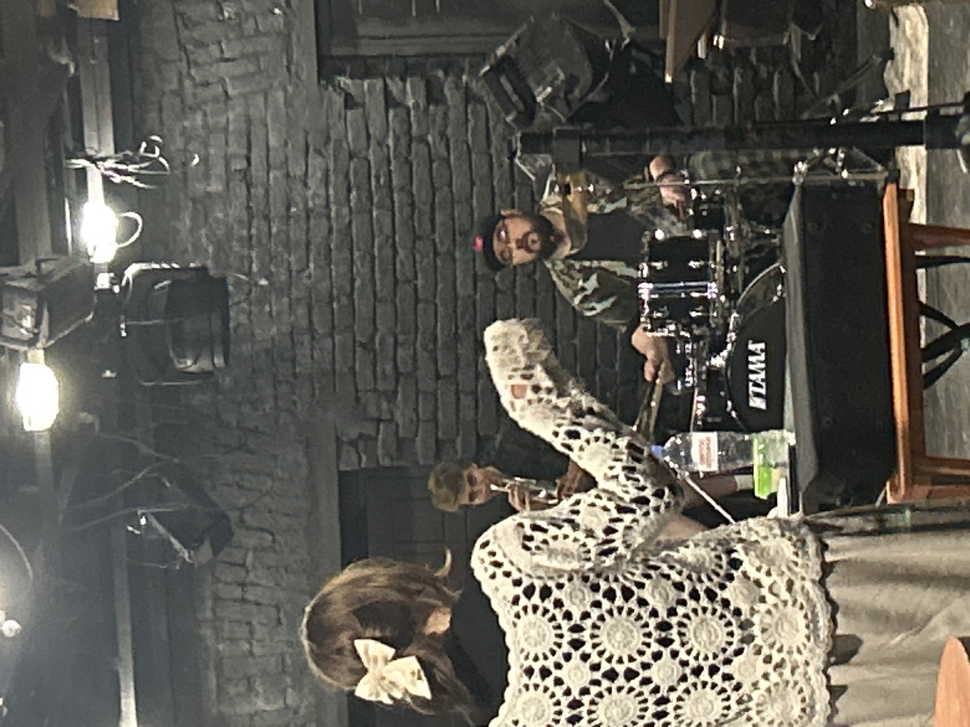 Live jazz performance captured in brick-walled venue