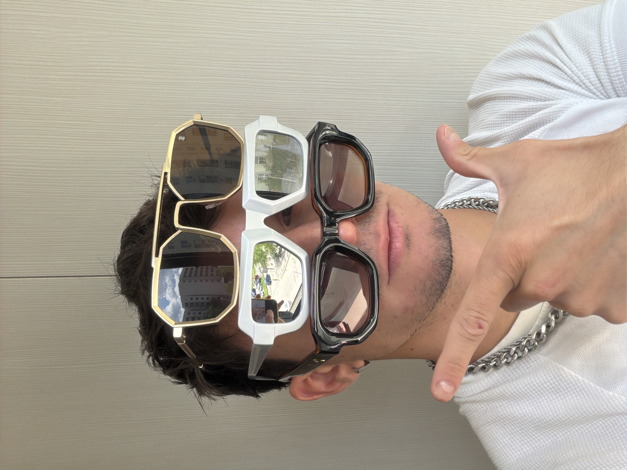 Man wears three pairs of sunglasses in Sofia fashion photos