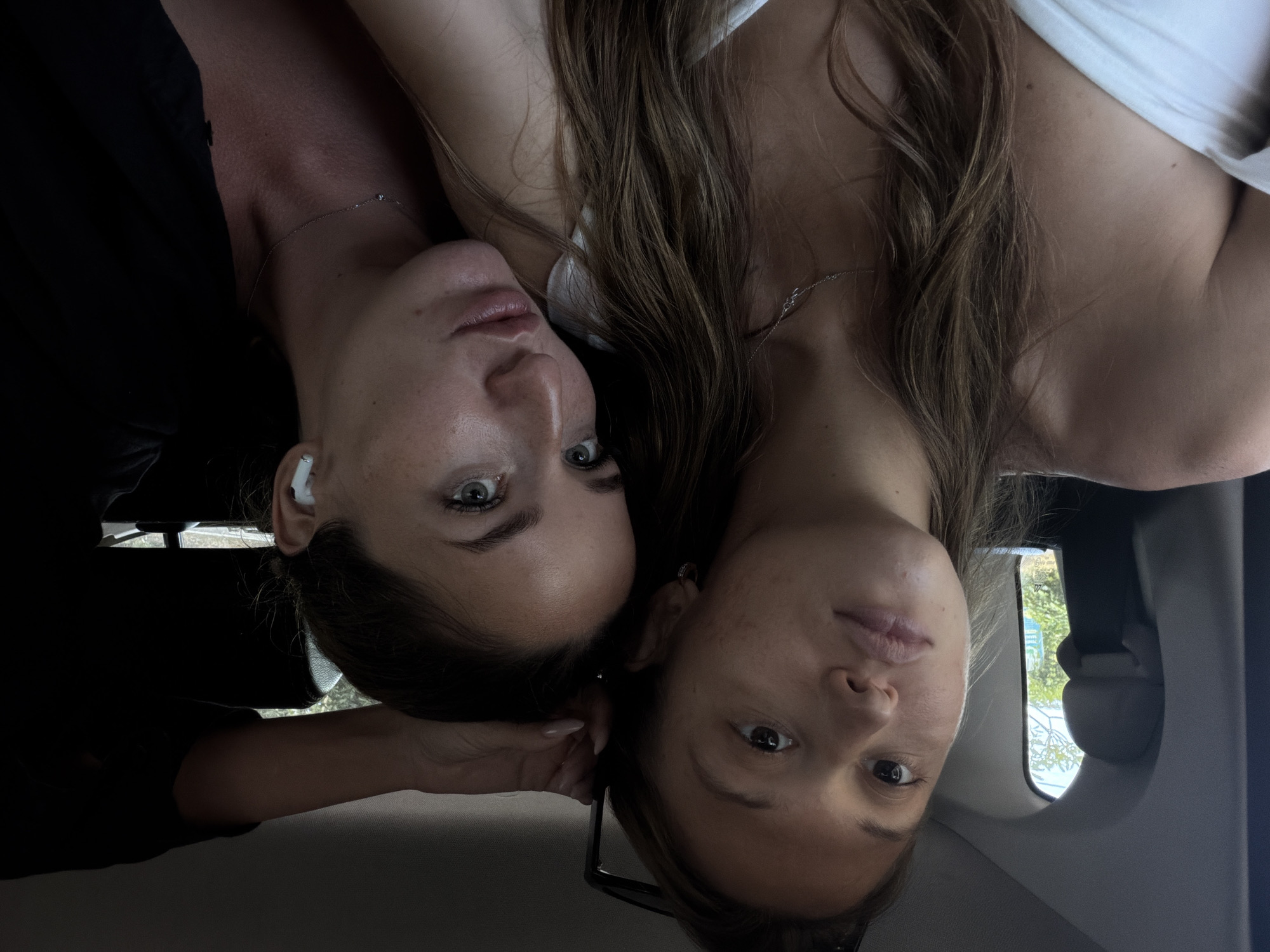 Two women photographed upside down in car in Karangasem