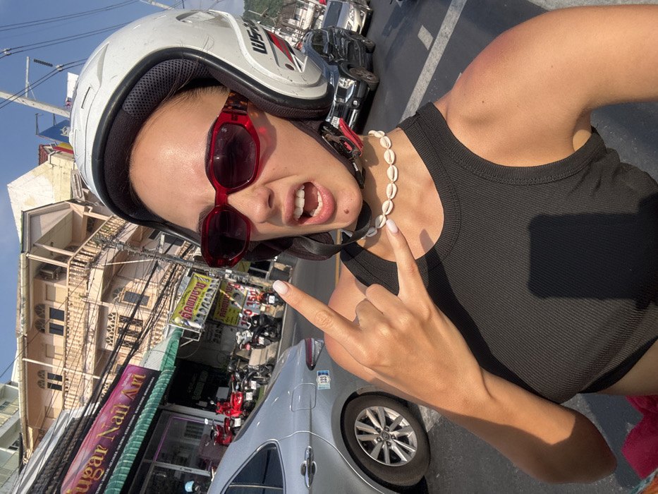 Scooter riders capture selfie moment in sunny Patong Thailand