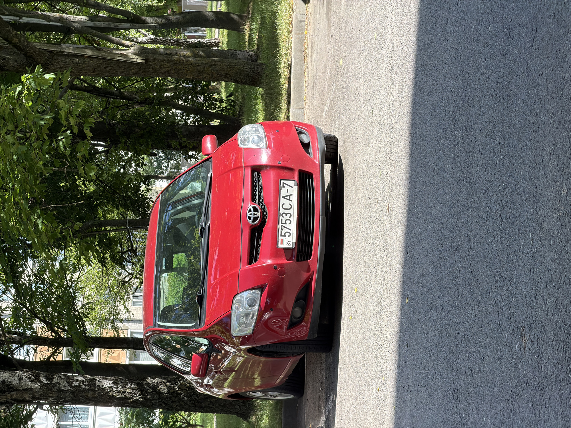 Three parked cars outside a Minsk apartment block