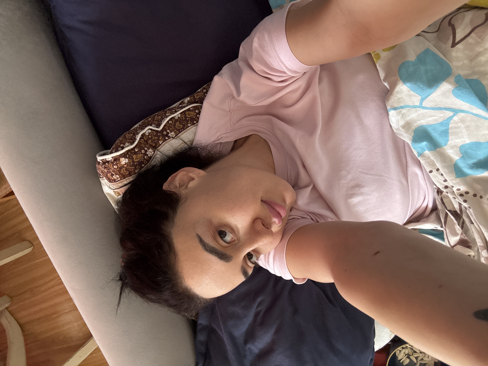 Morning documentation in Tbilisi bedroom features selfie, decorative dreamcatcher