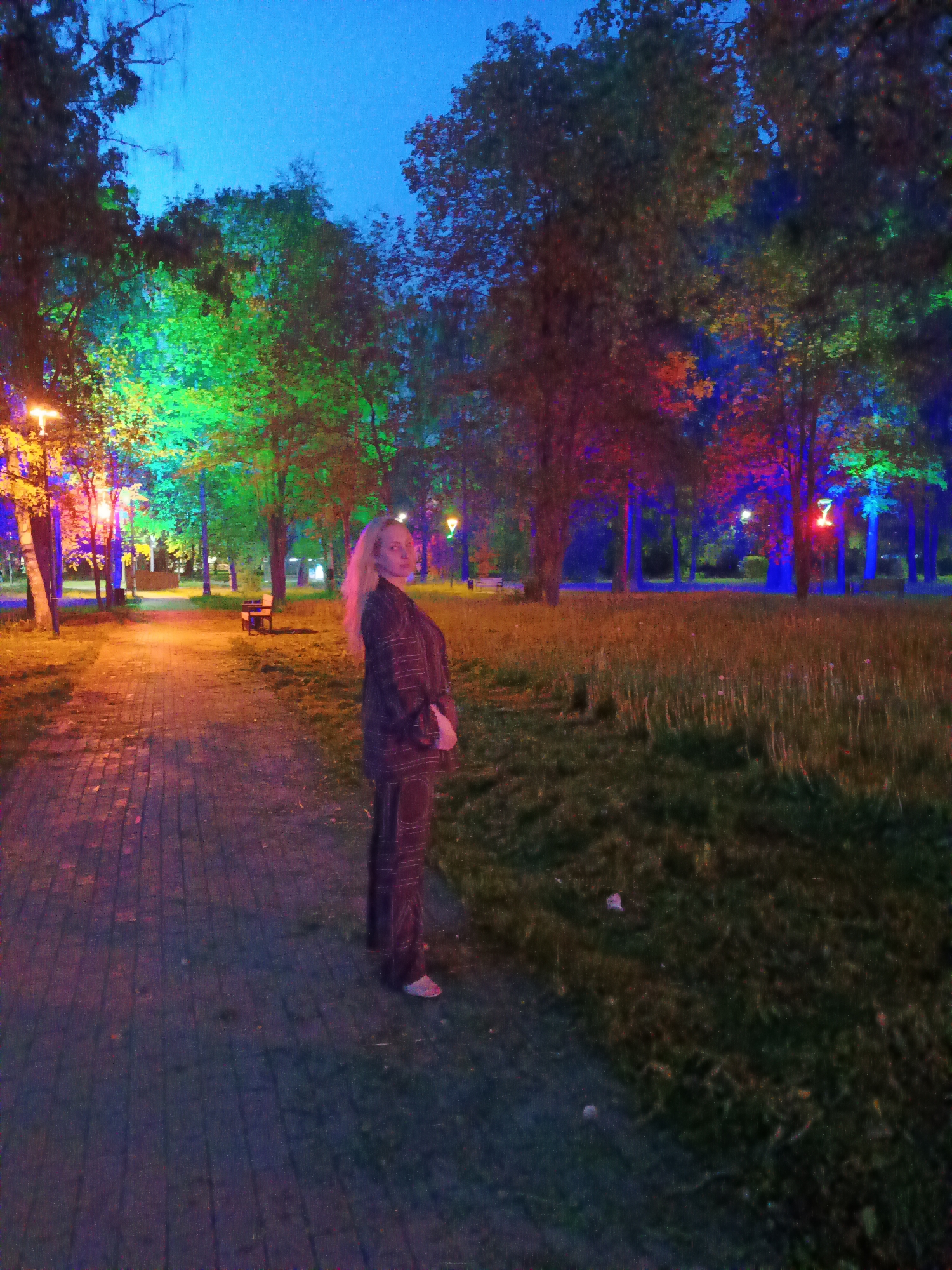 Woman photographs evening walk in Cherepovets park