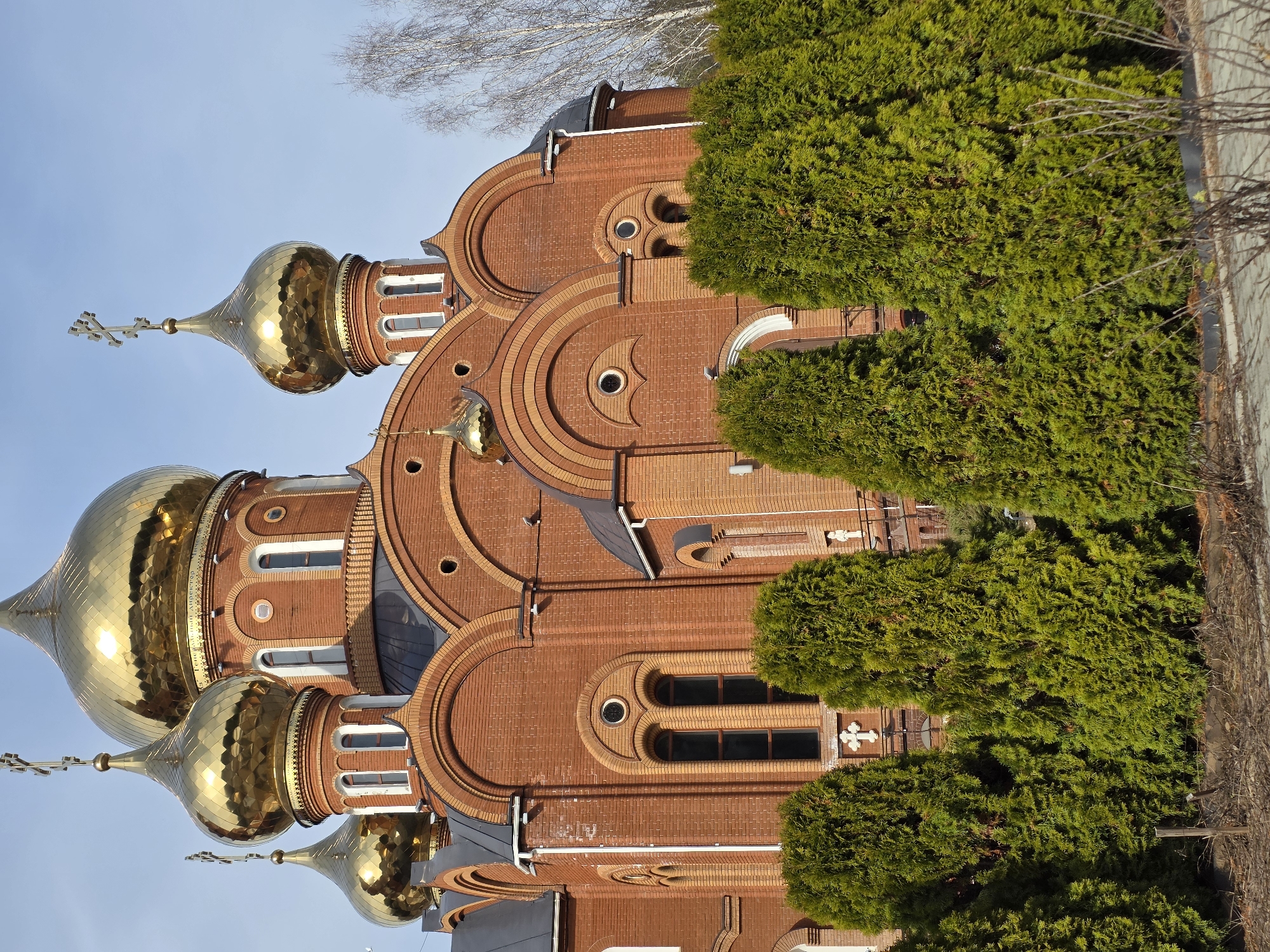 Child plays soccer near Orthodox cathedral in Chaikovsky, Russia