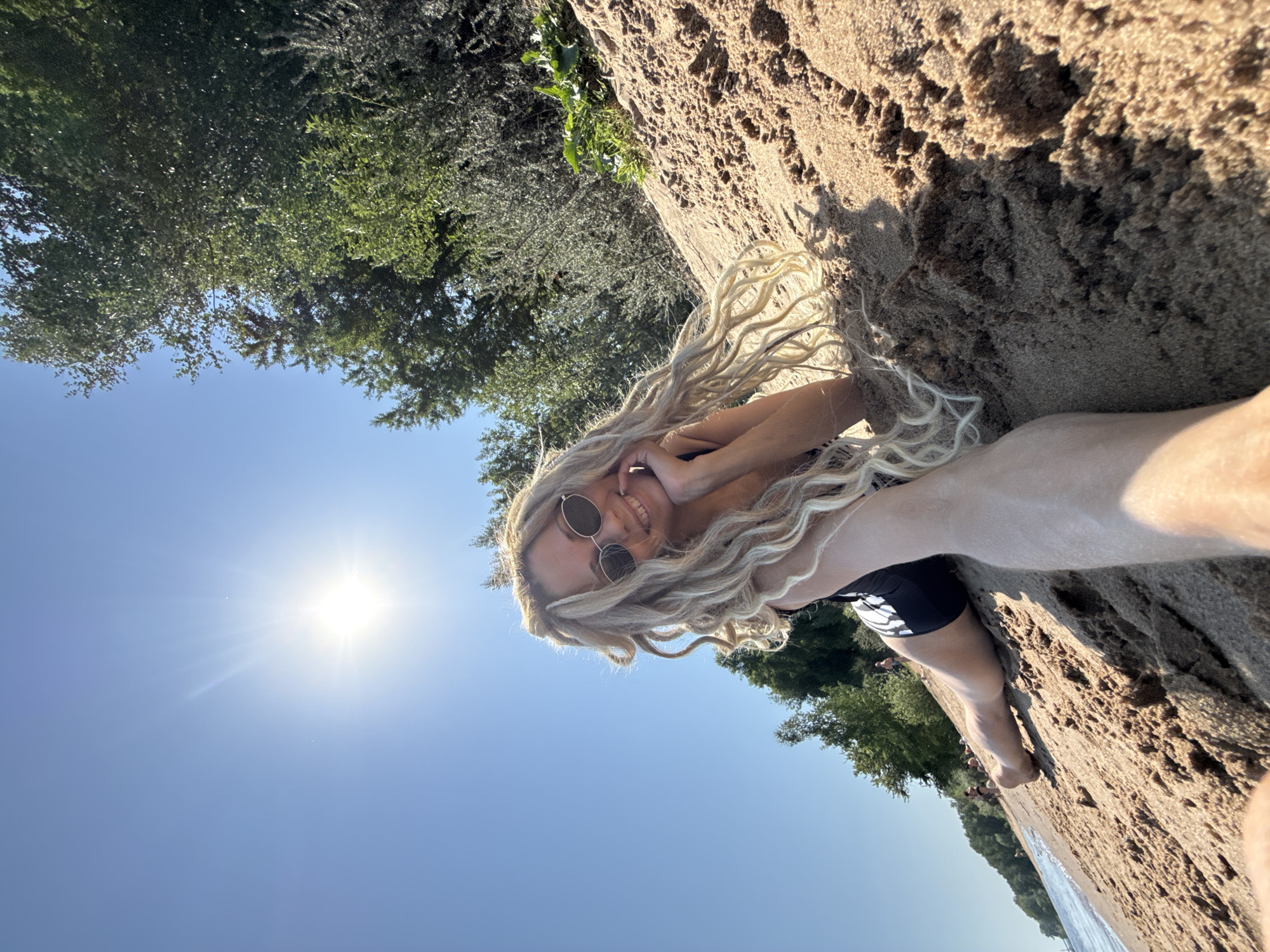 Woman enjoys beach activities in Rusanovo, performs backflip
