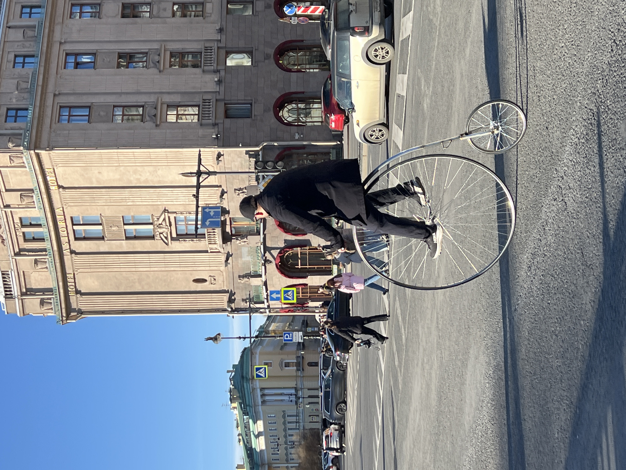 Man rides vintage penny-farthing bicycle through Saint Petersburg streets