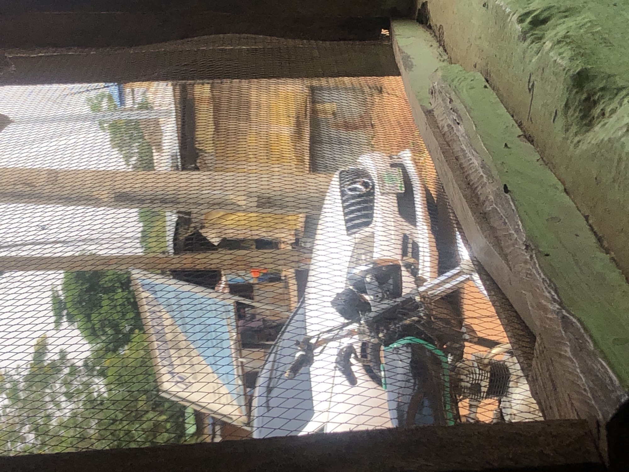 Urban street scenes captured through security fencing