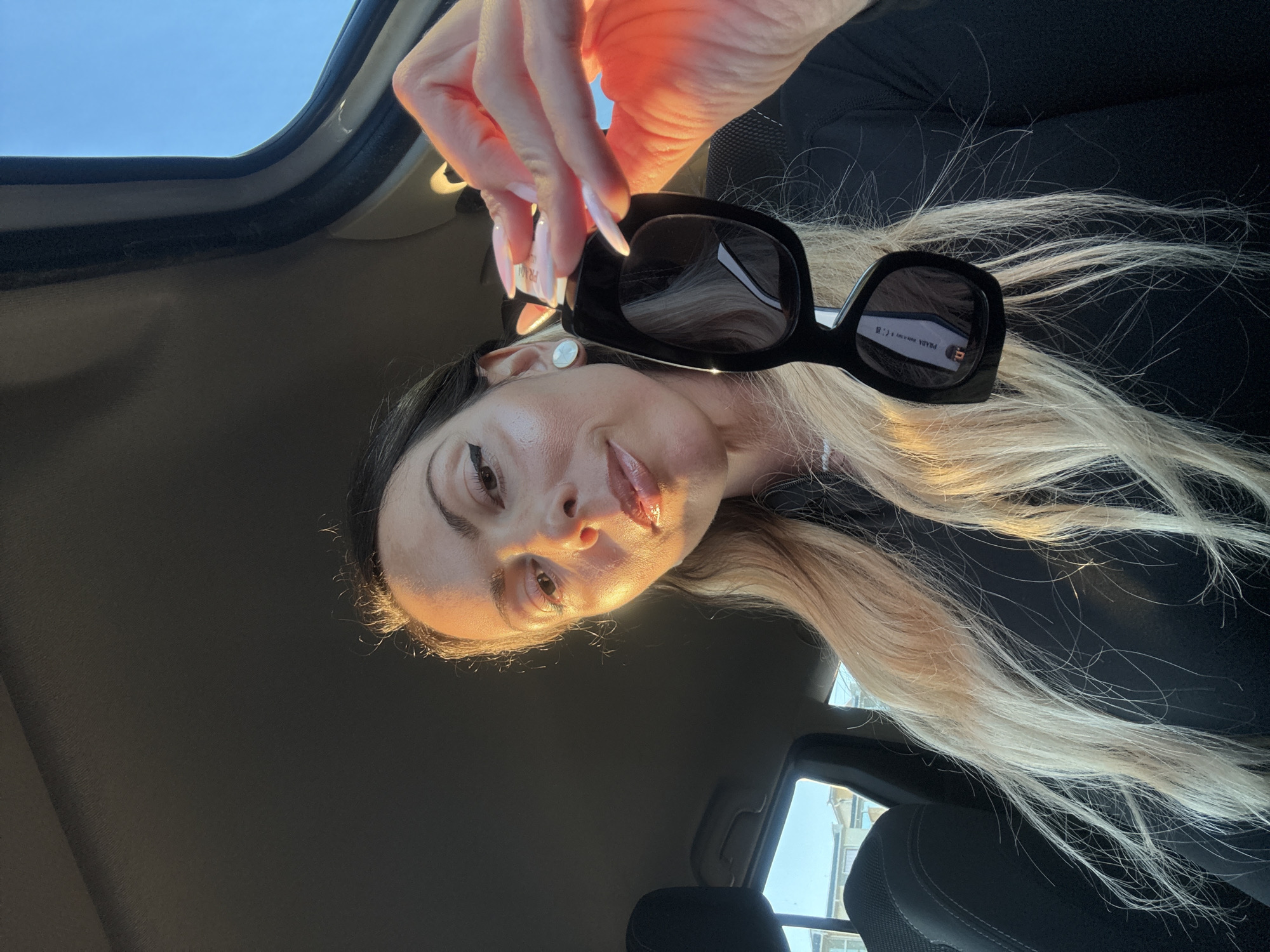 Woman photographed with sunglasses inside car in Ravda, Bulgaria