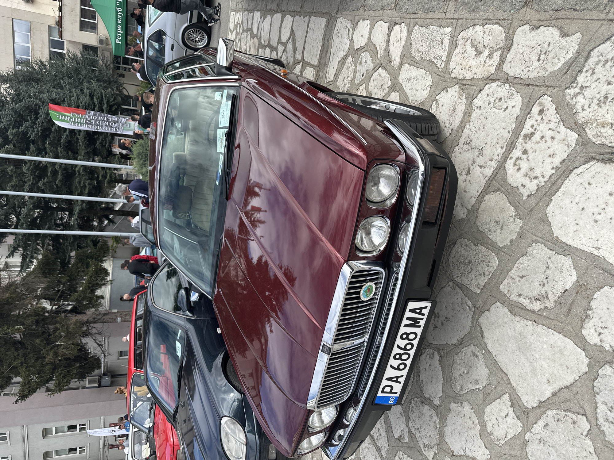 Vintage car gathering documented on stone streets in Razlog