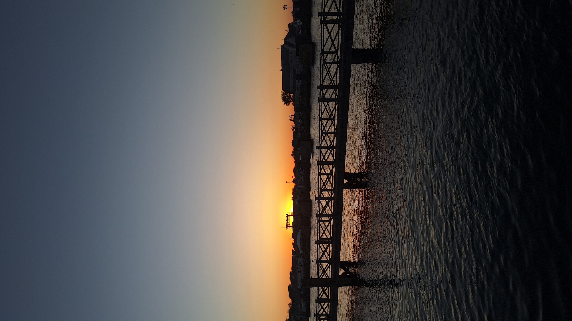 Sunset views across Nantucket harbor with pier and boats