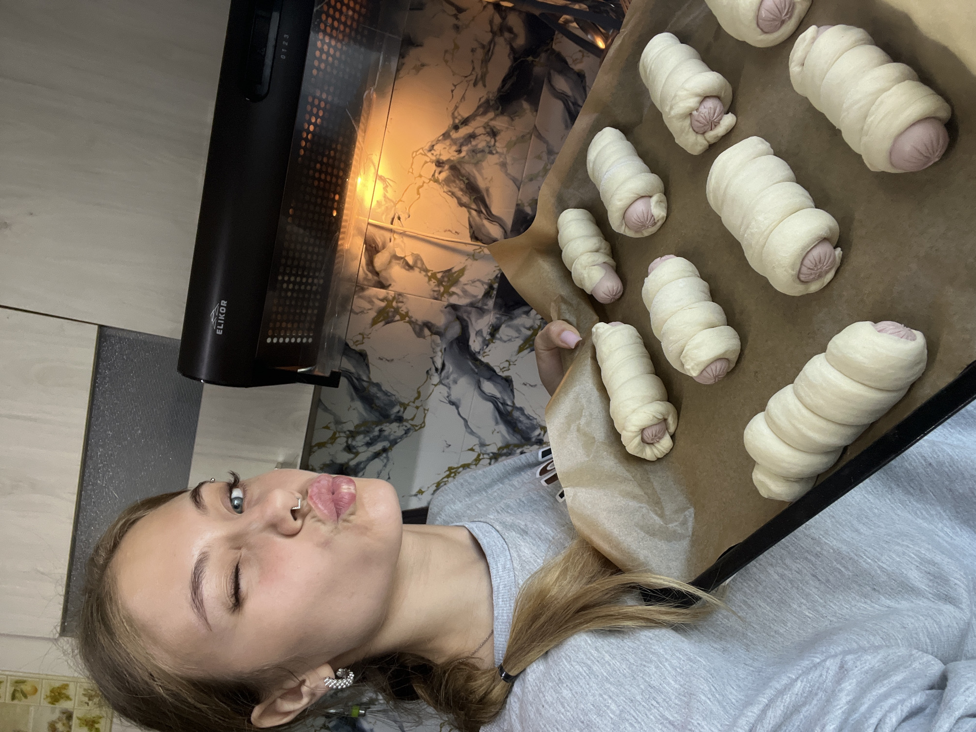 Woman prepares pigs in blanket for early morning baking