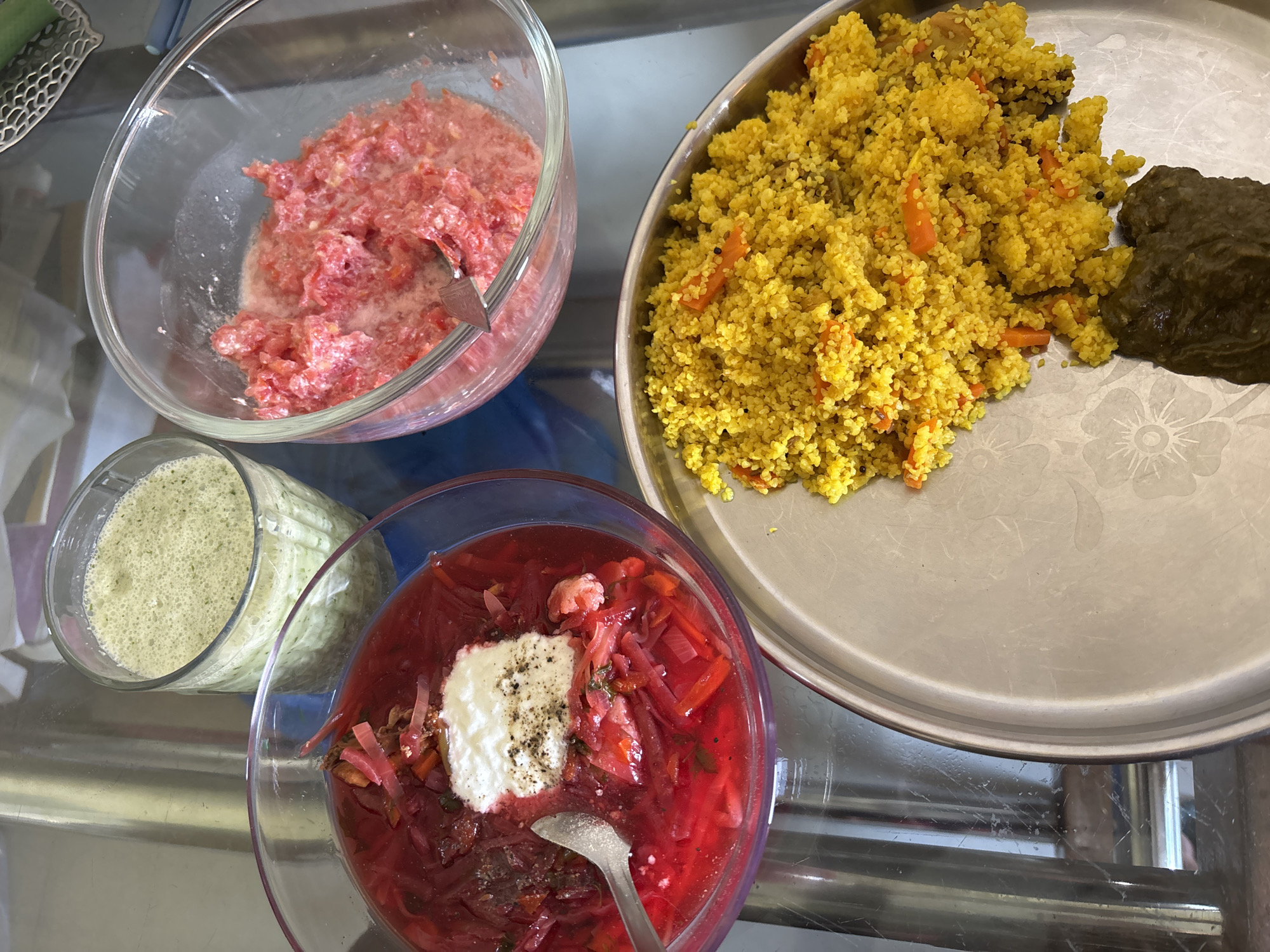 Food dishes arranged on glass table in Ambernath