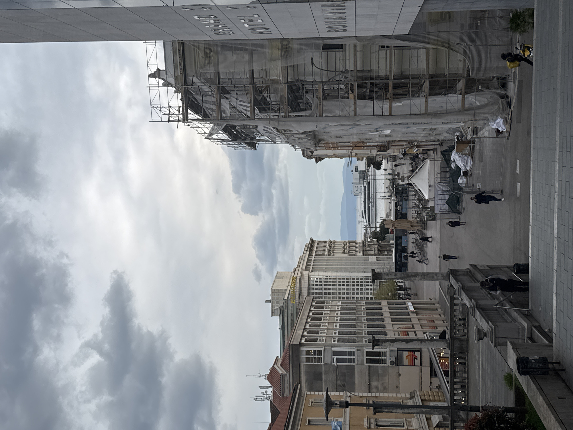 Pedestrians captured on Rijeka city streets during cloudy afternoon
