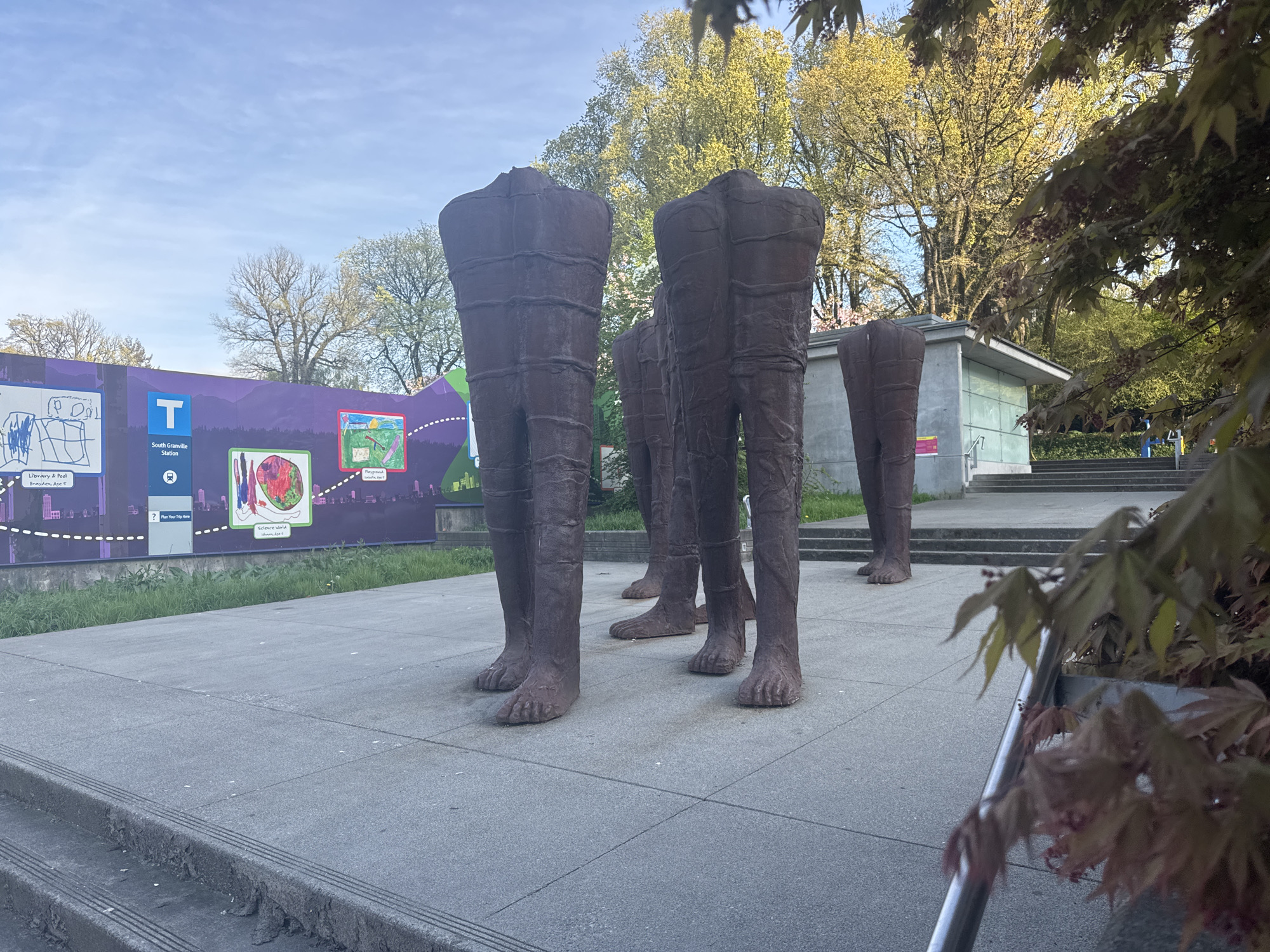 Bronze leg sculptures documented at Vancouver transit plaza