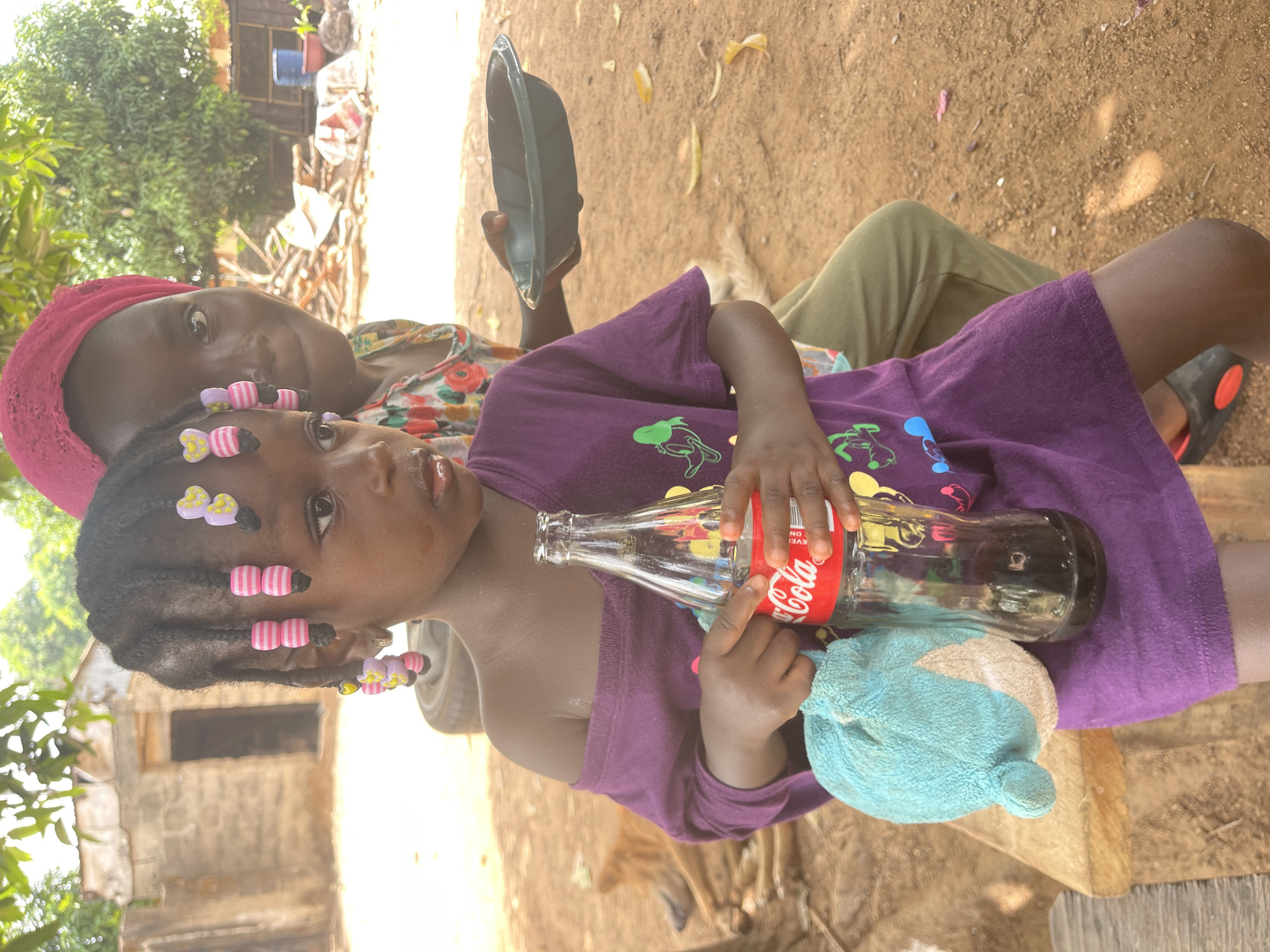 Child enjoys Coca-Cola in rural Nigerian town