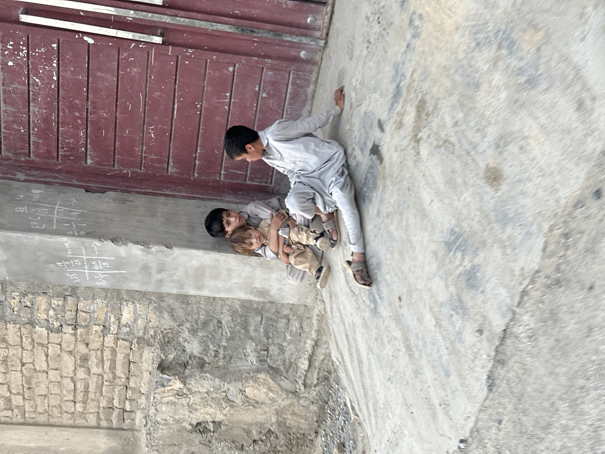 Street scenes from Quetta: a doorway moment and a motorcycle ride