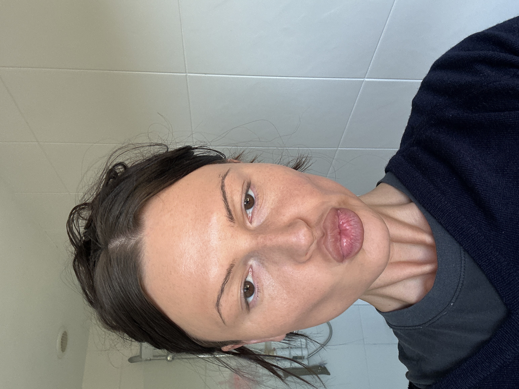 Woman photographed making blowing gesture in Wealden, UK