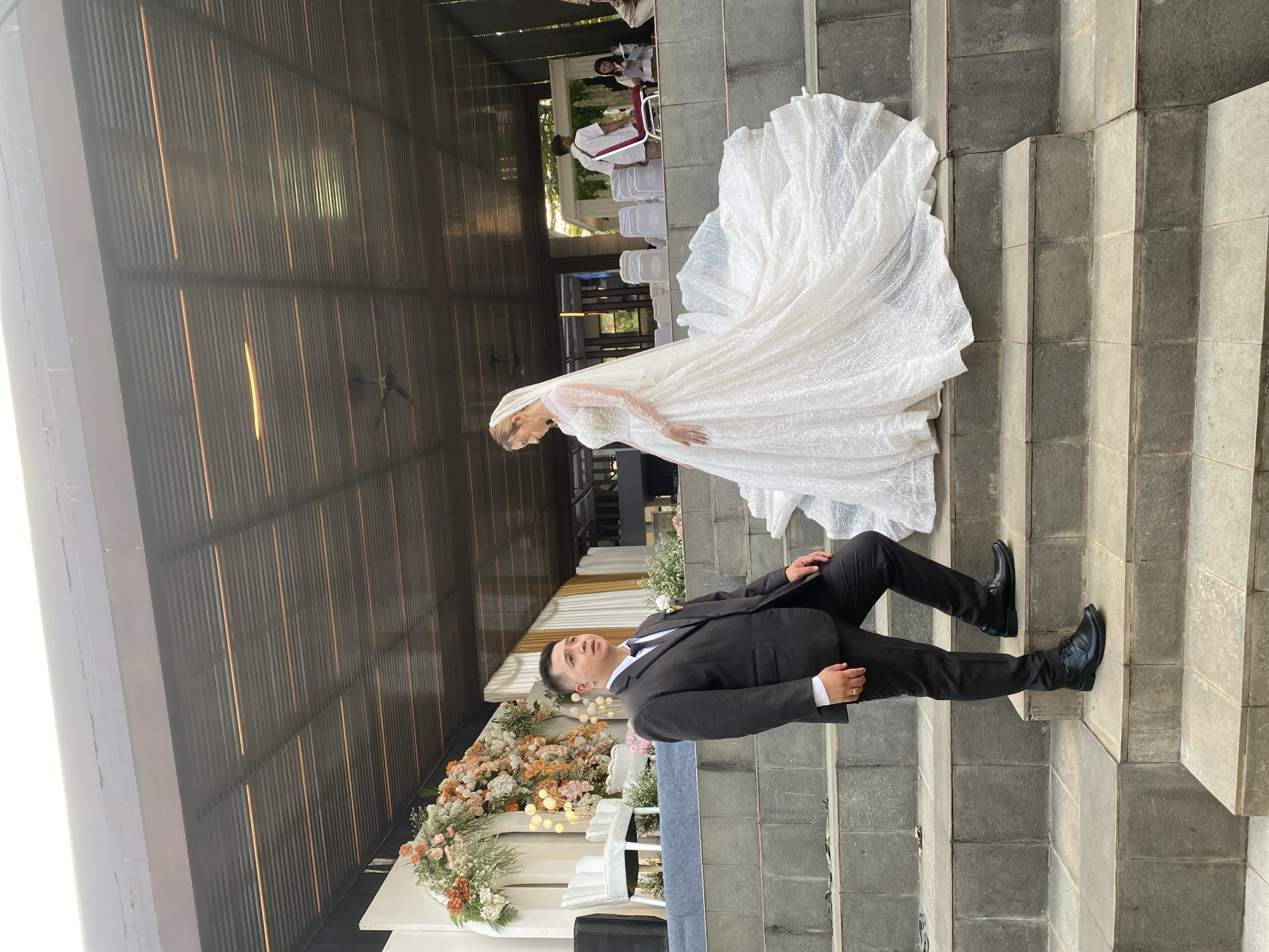 Outdoor wedding ceremony on stone steps in Bekasi