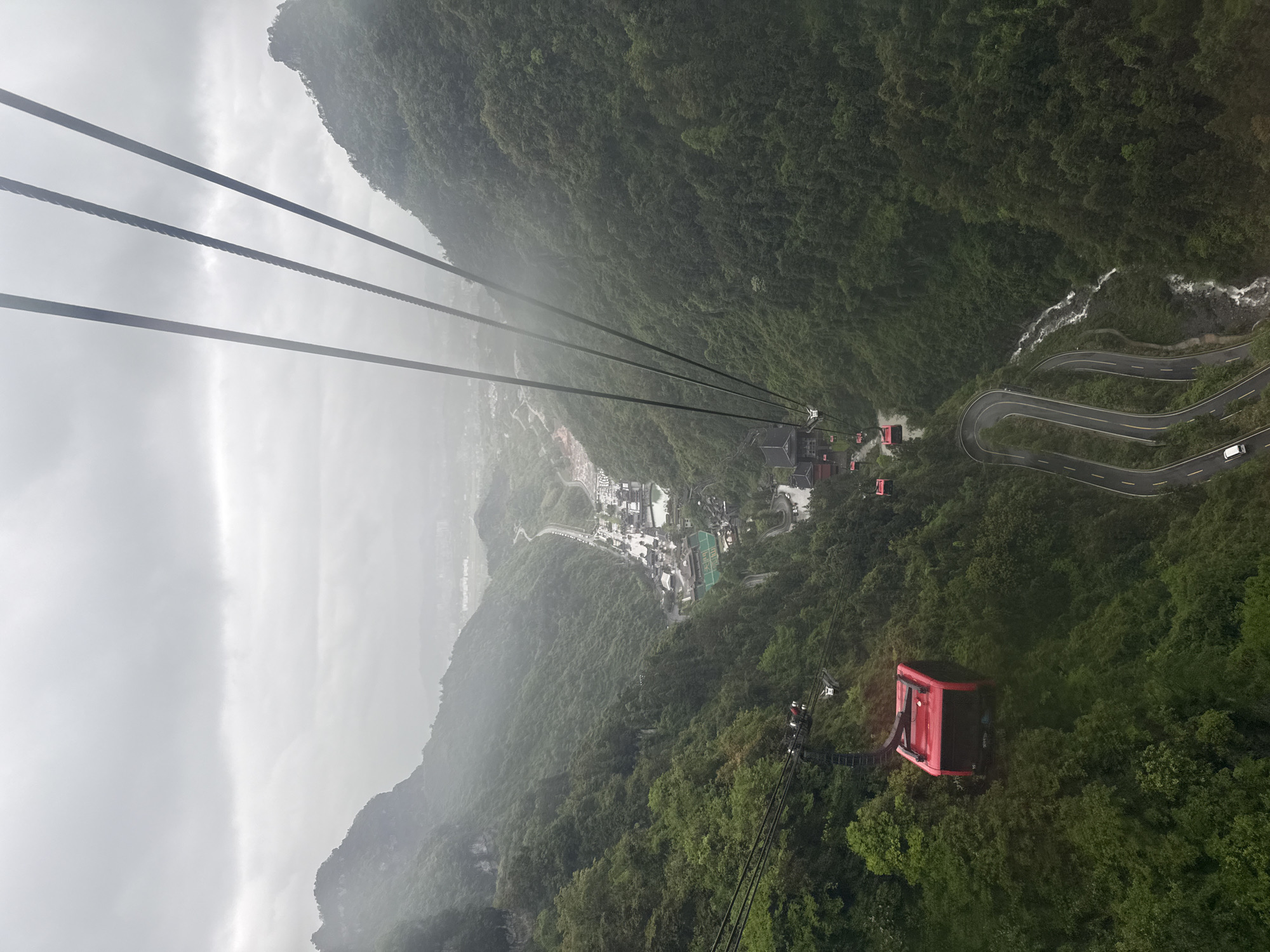 Cable car operates through misty Zhangjiajie forest landscape