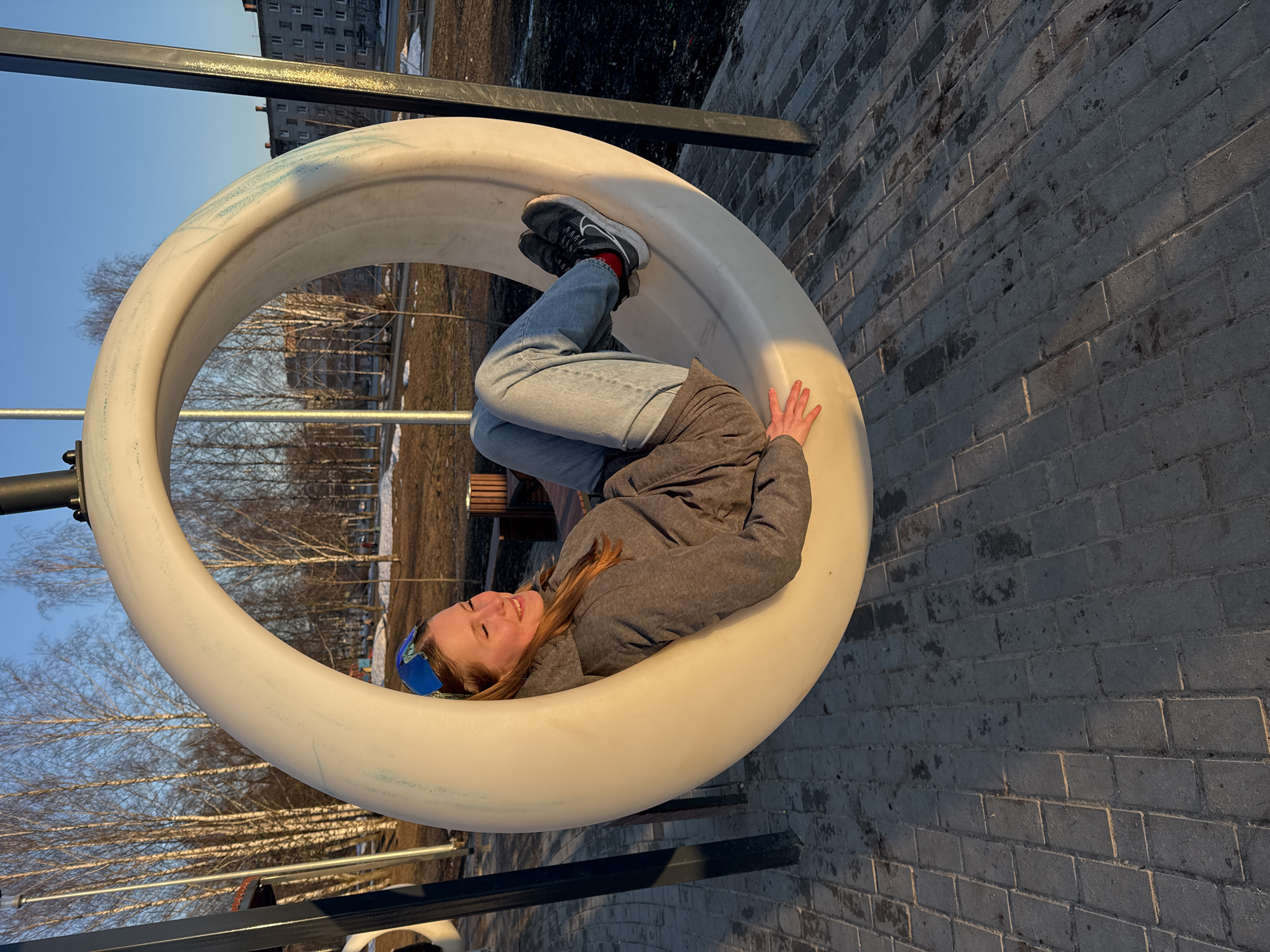 Woman enjoys afternoon at Berezniki playground near cathedral