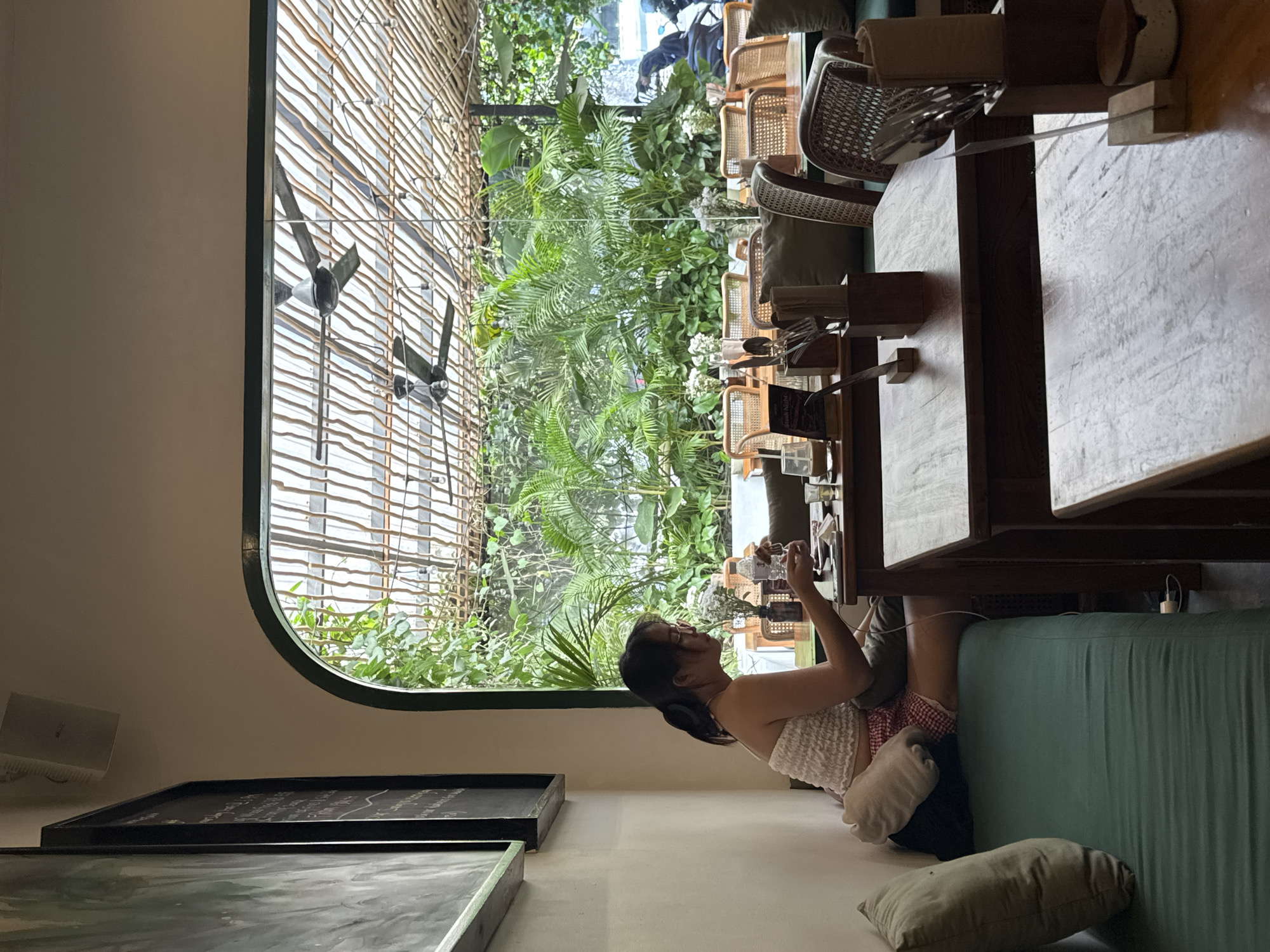 Woman enjoys morning routine in Kuta Selatan café setting