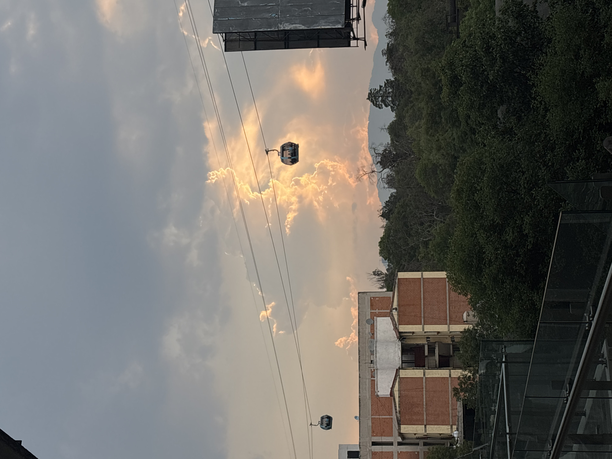 Cable cars operate in Mexico City under cloudy skies
