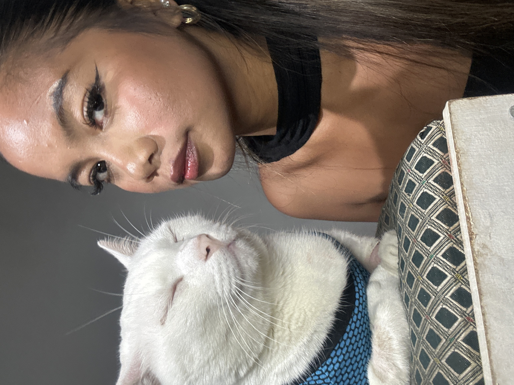 Woman poses with harnessed white cat in Jakarta selfie session