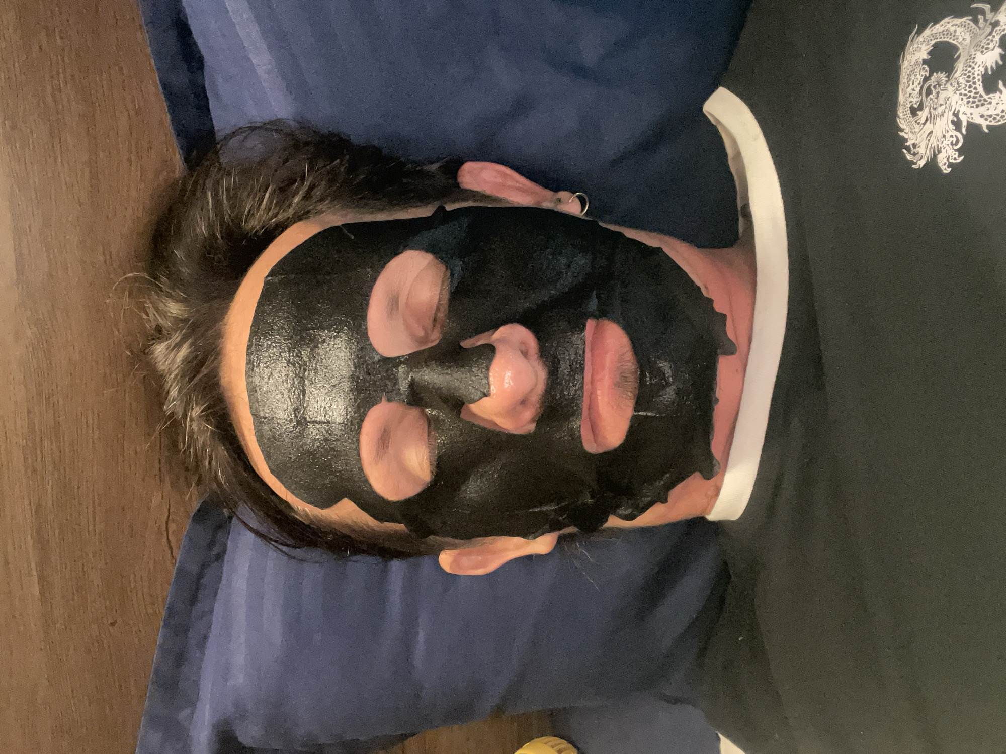 Person in face mask rests on pillow in Mumbai