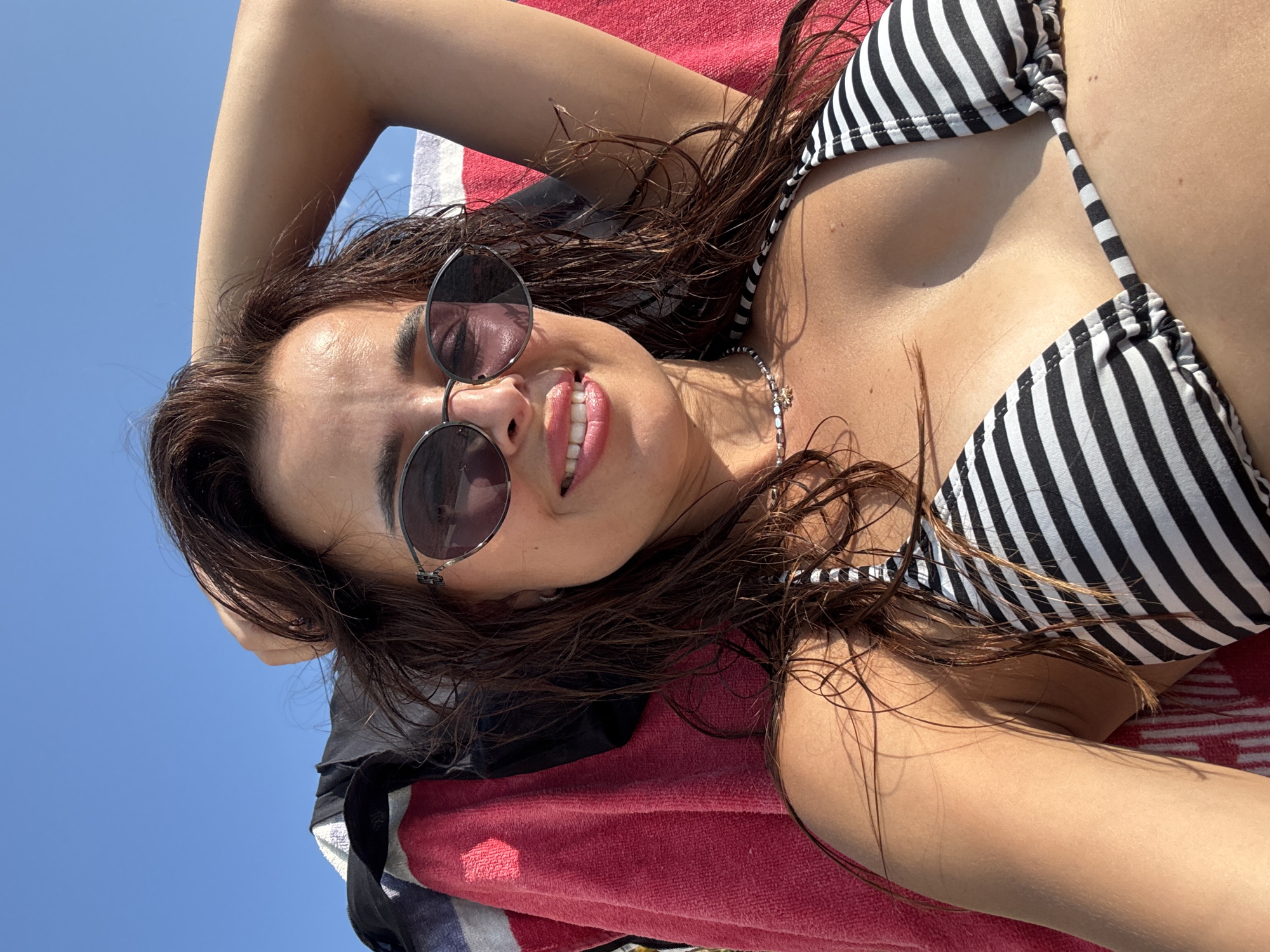 Lazy beach afternoon on a pebble shore, sun and swim vibes
