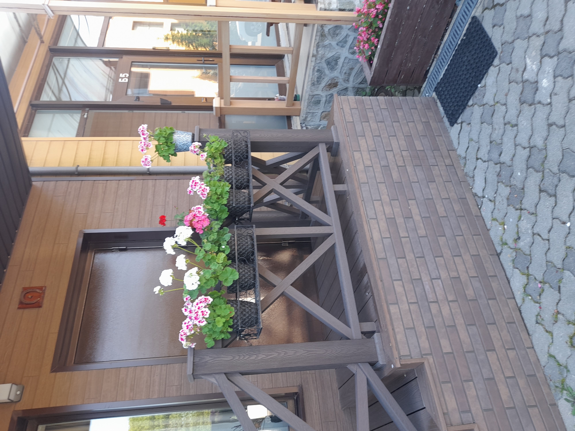 Geraniums and a wooden porch entrance, Vladivostok