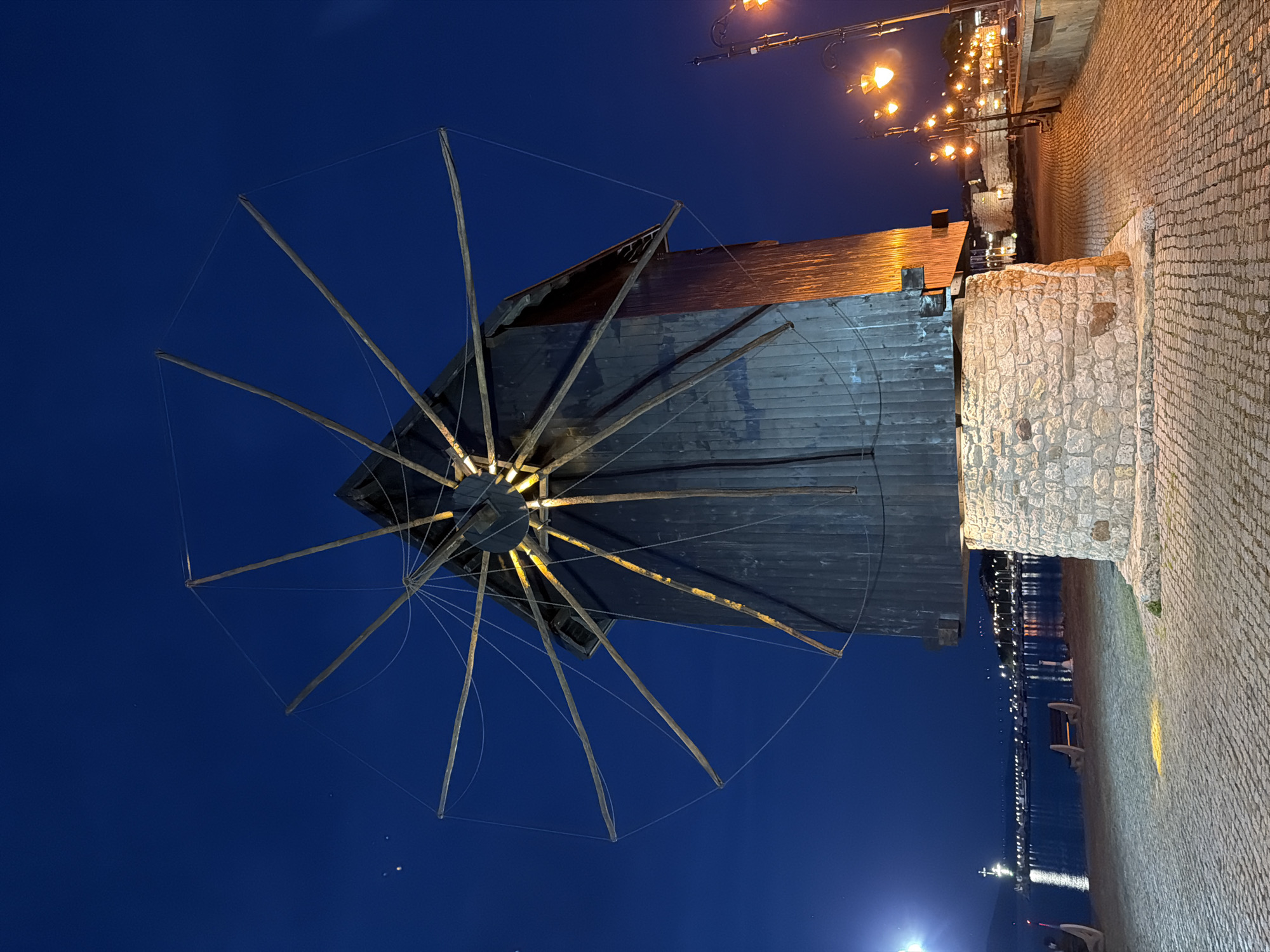 Evening tourism activity centers around historic Nesebar windmill landmark