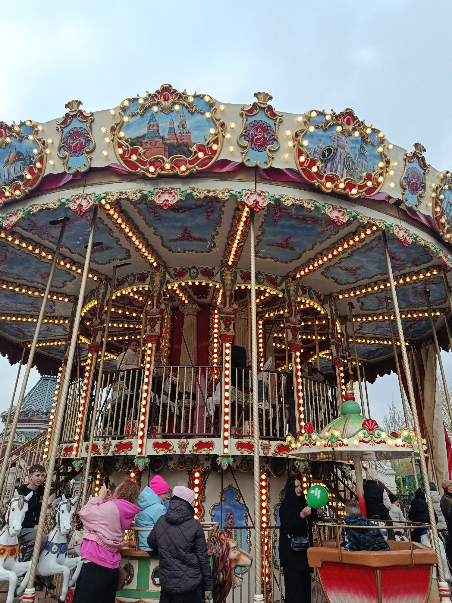 Illuminated carousel operates in Moscow amid overcast afternoon