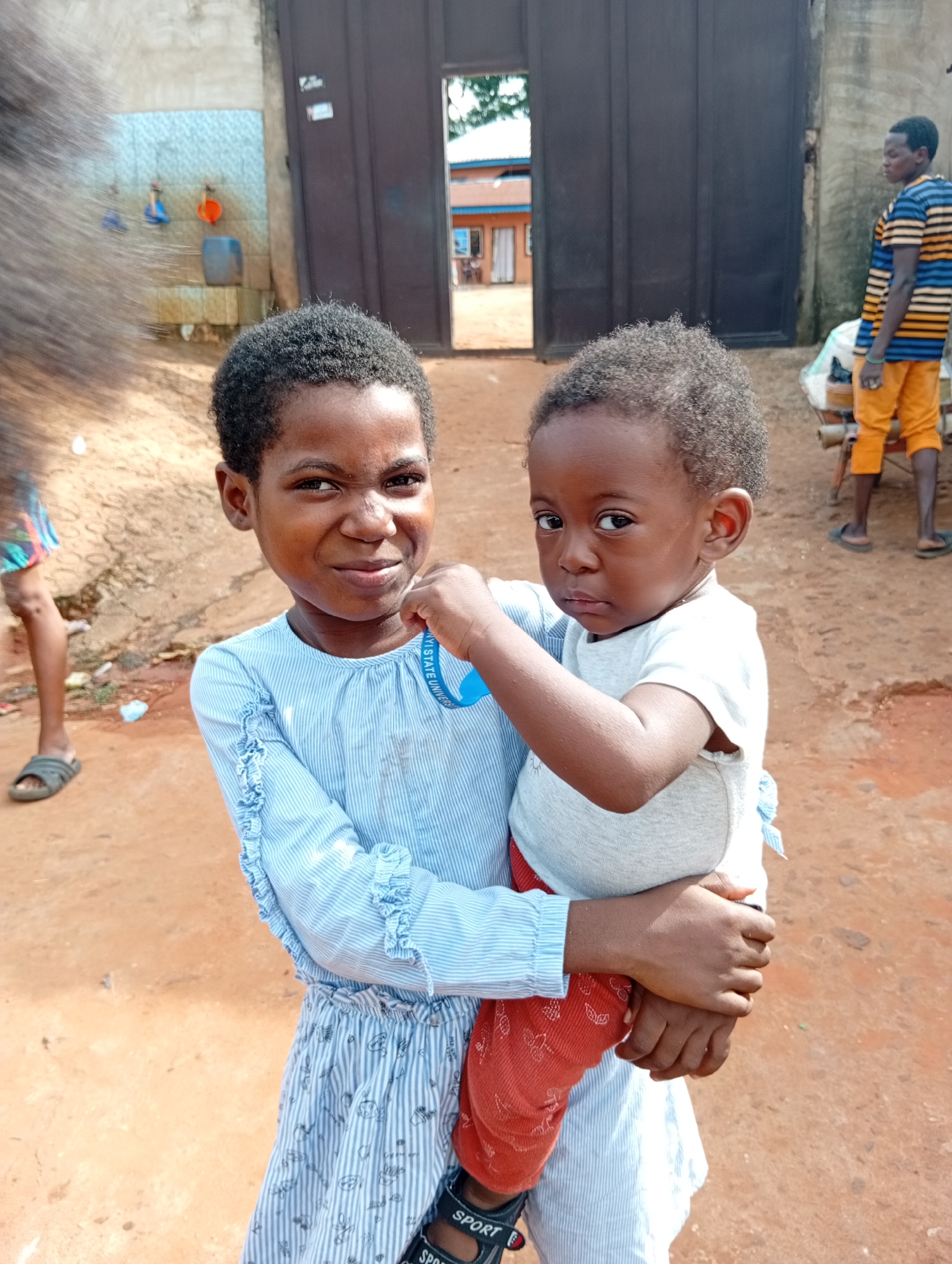 Daily life scenes include childcare and tailoring work