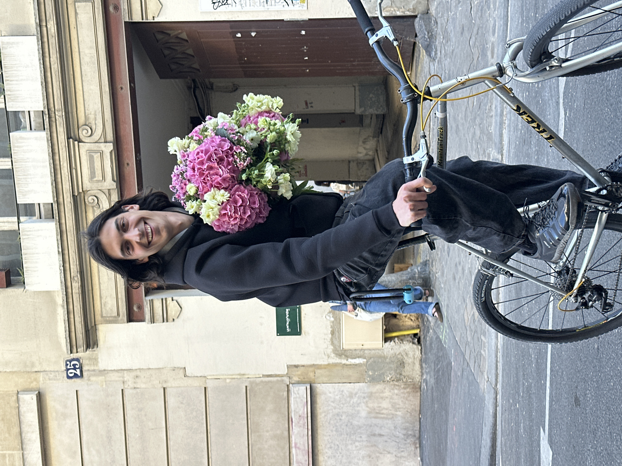 Cyclist with flowers spotted on narrow Paris street