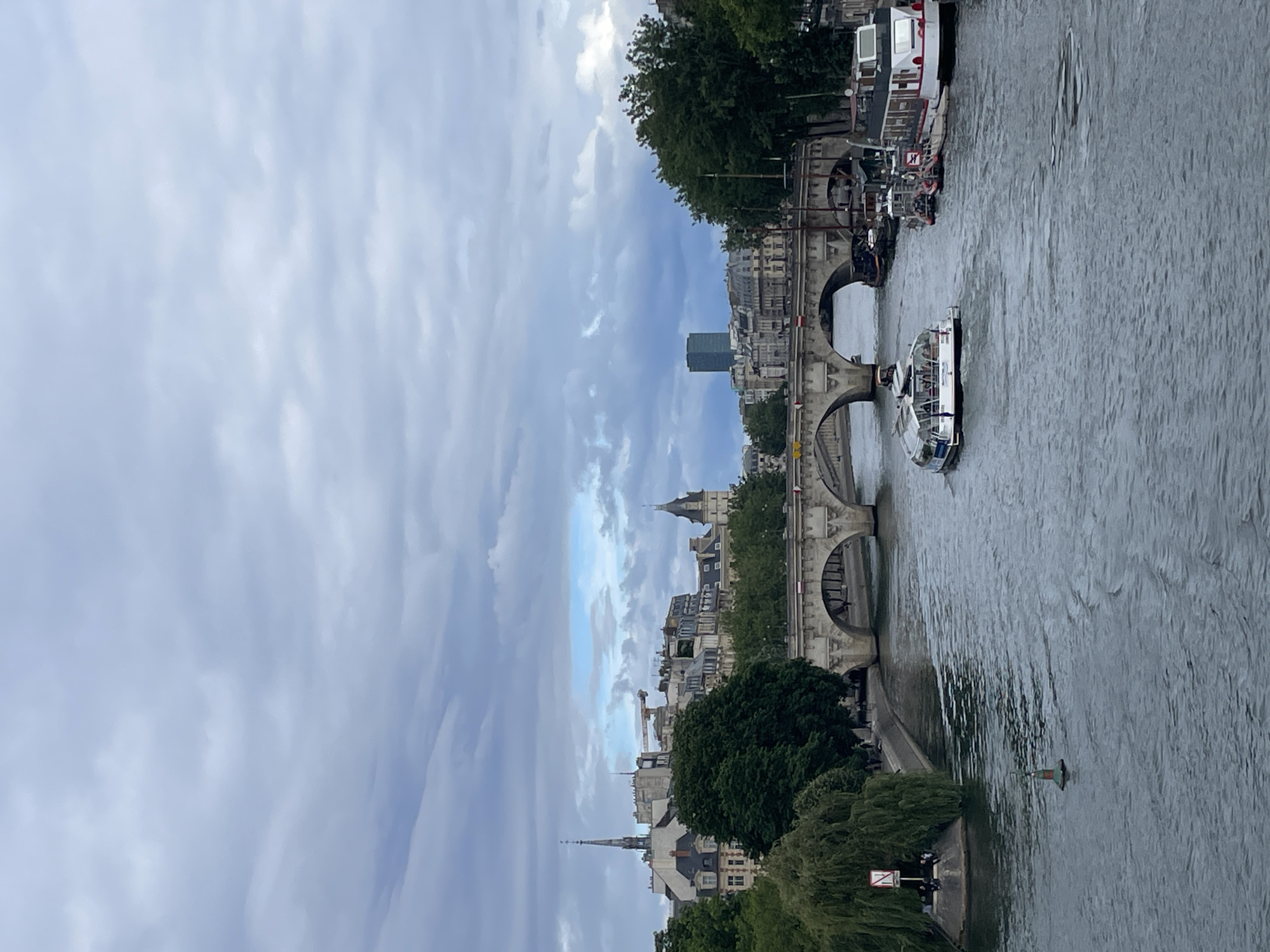 Seine River boat traffic observed near wrapped Pont Neuf bridge