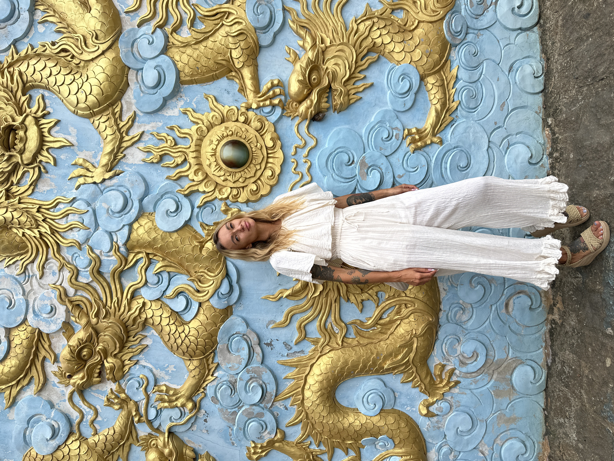 Woman photographs at ancient temple ruins in Mũi Né