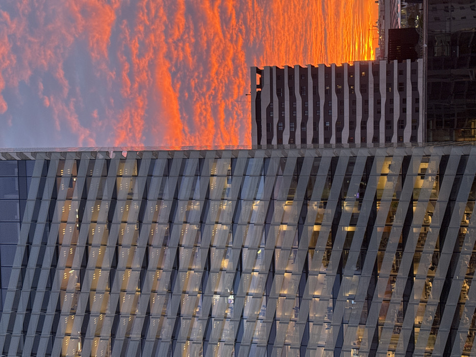 Dramatic sunrise illuminates Barcelona metro skyline with geometric architecture