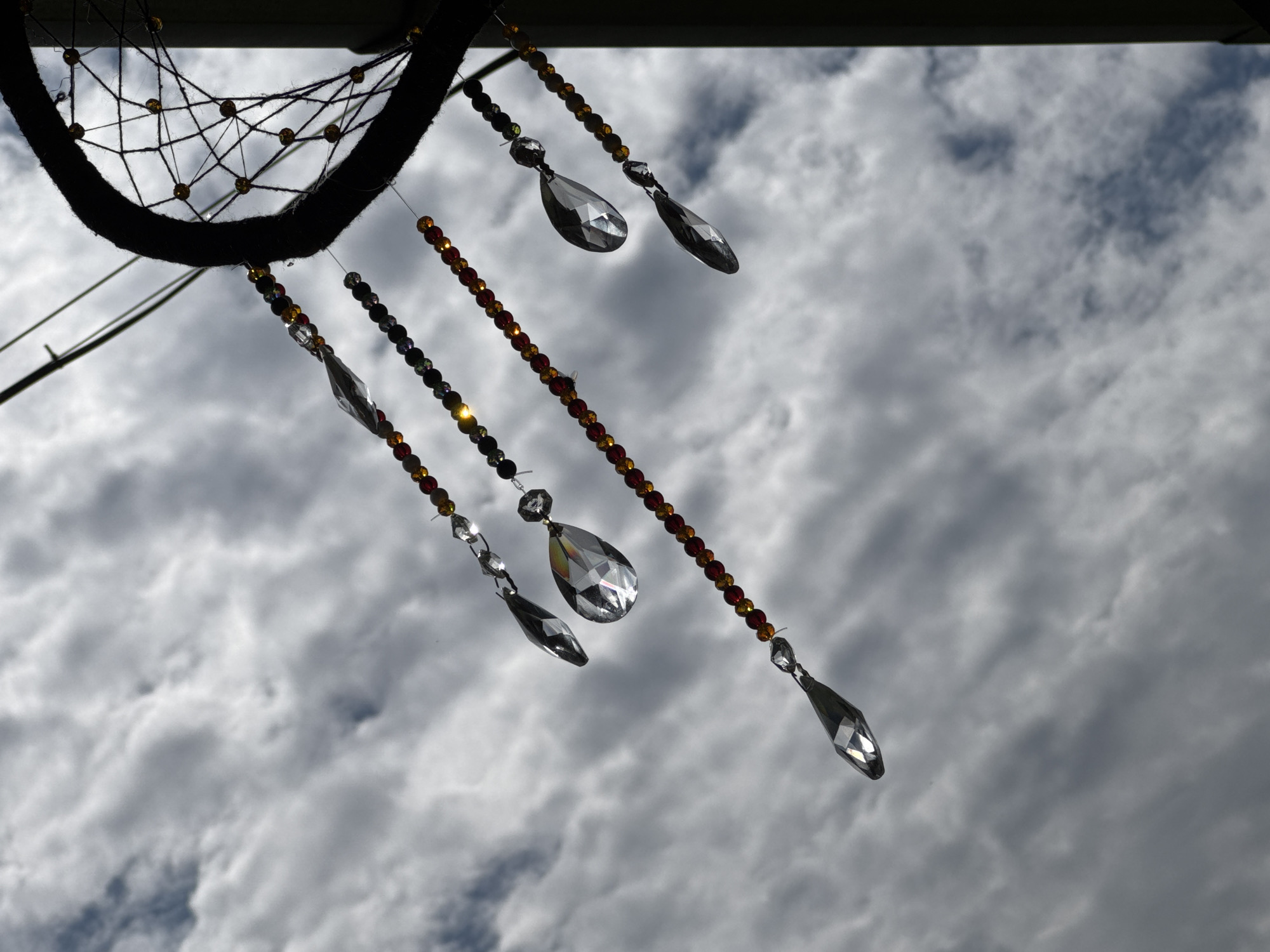 Dreamcatchers hanging outdoors against Chemal's mountain sky