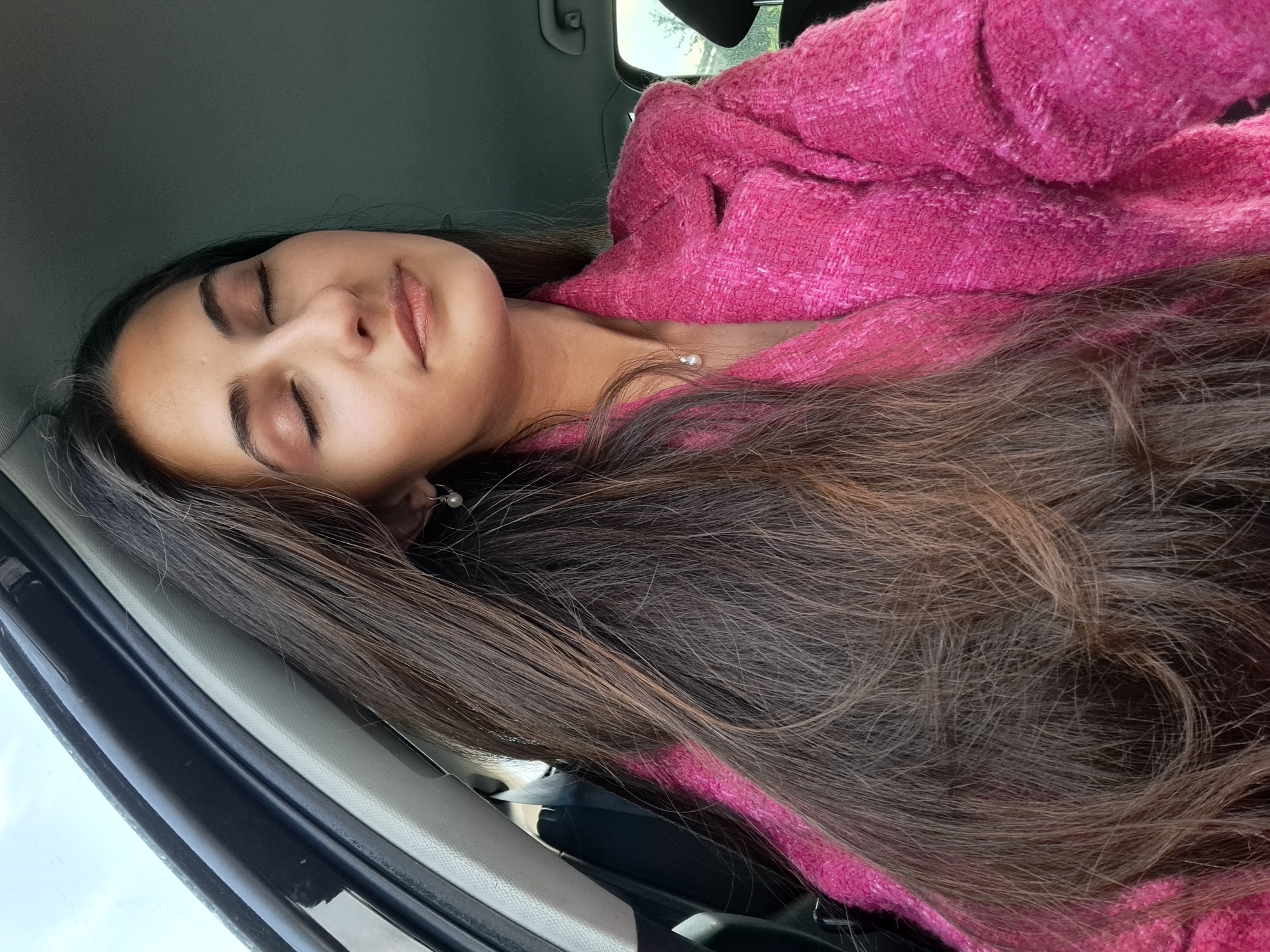 Woman rests peacefully inside car during early morning hours