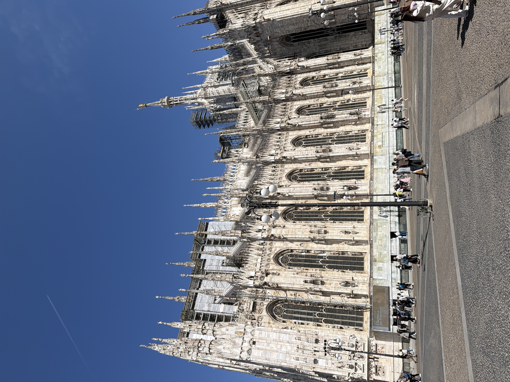 Milan visitors document cathedral architecture and outdoor dining experiences