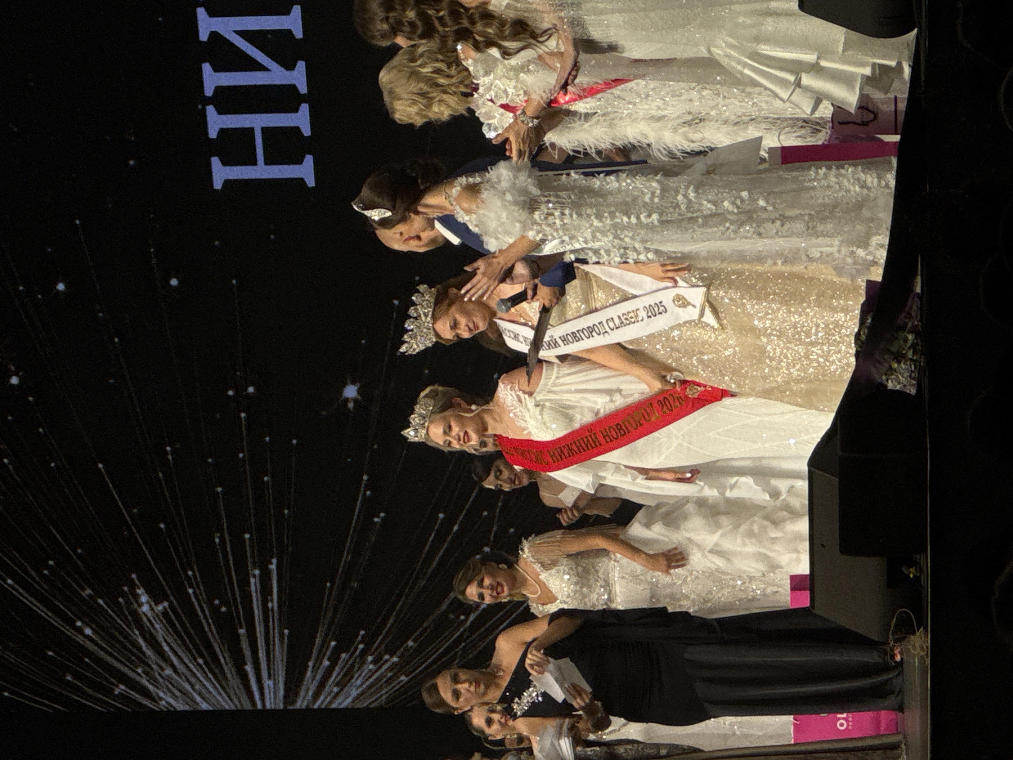 Beauty pageant contestants gather on stage for awards ceremony