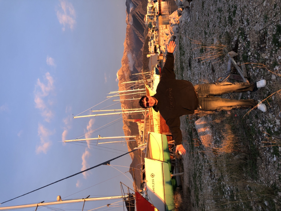 Person celebrates sunset moment at Bar Montenegro marina