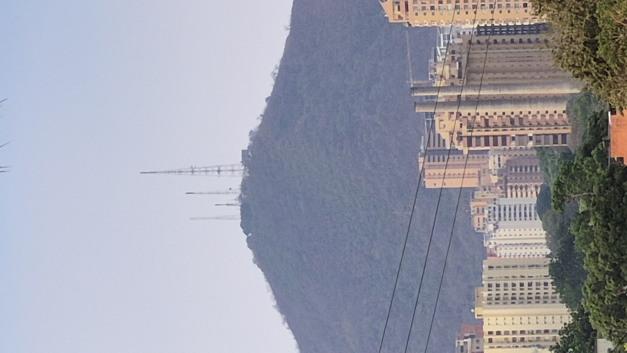 Valencia cityscape captured with mountain backdrop and communication towers