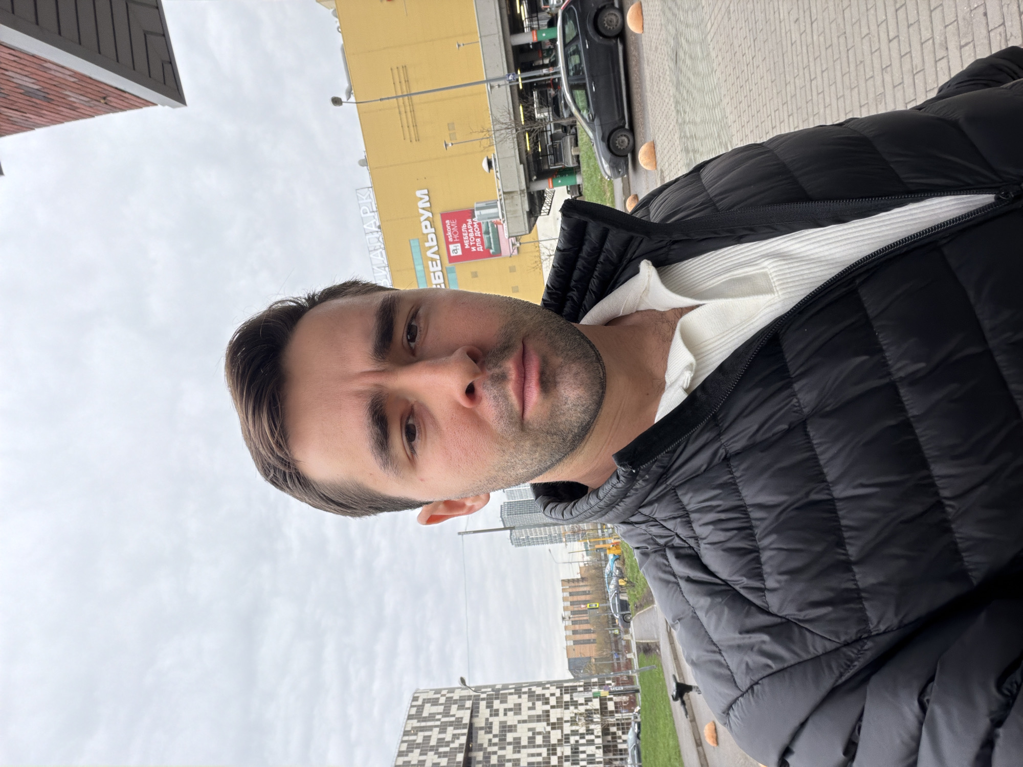 Man takes selfie on Moscow street near commercial building