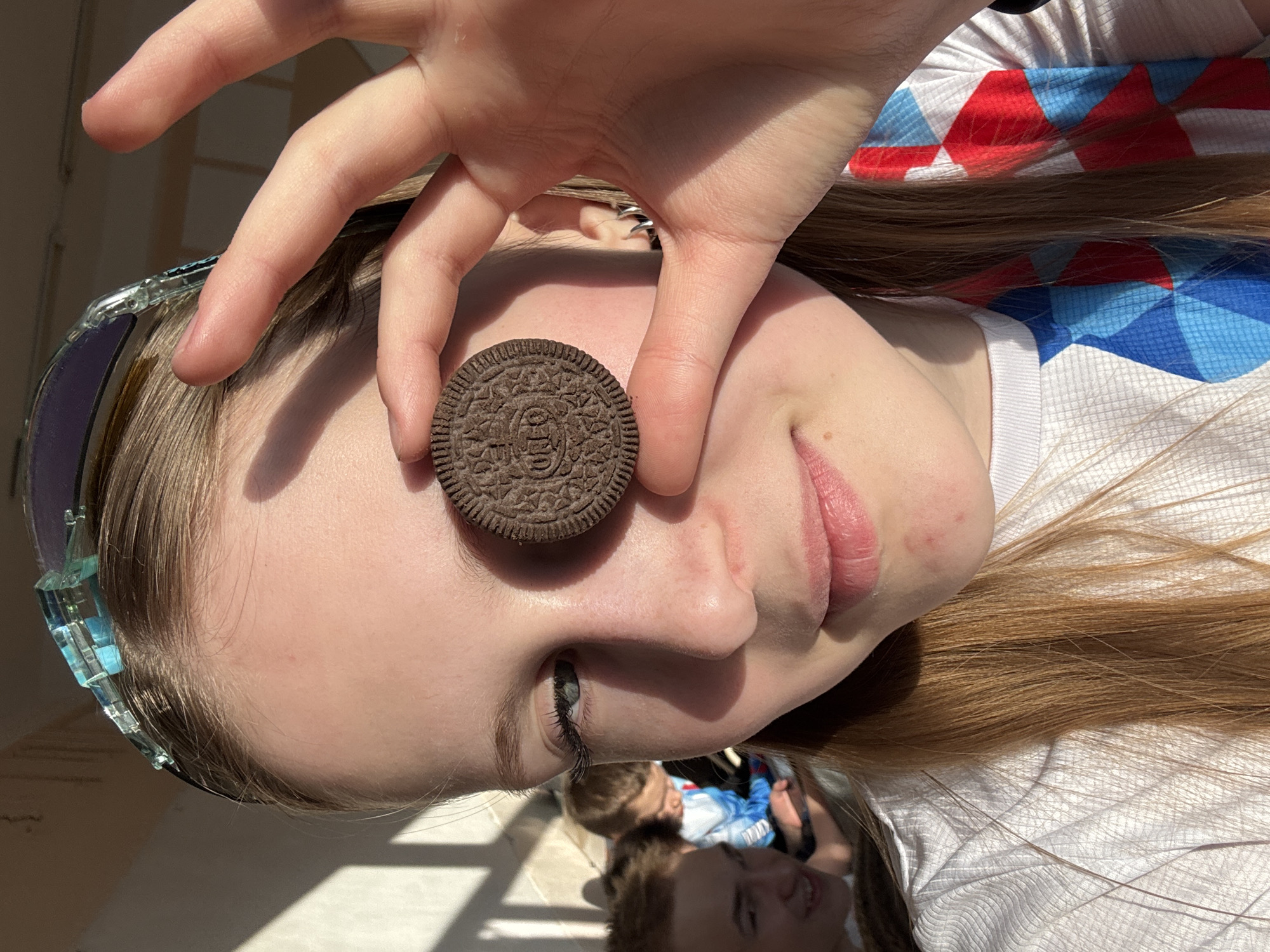 Person playfully poses with Oreo cookie in Yuzhnyy, Russia