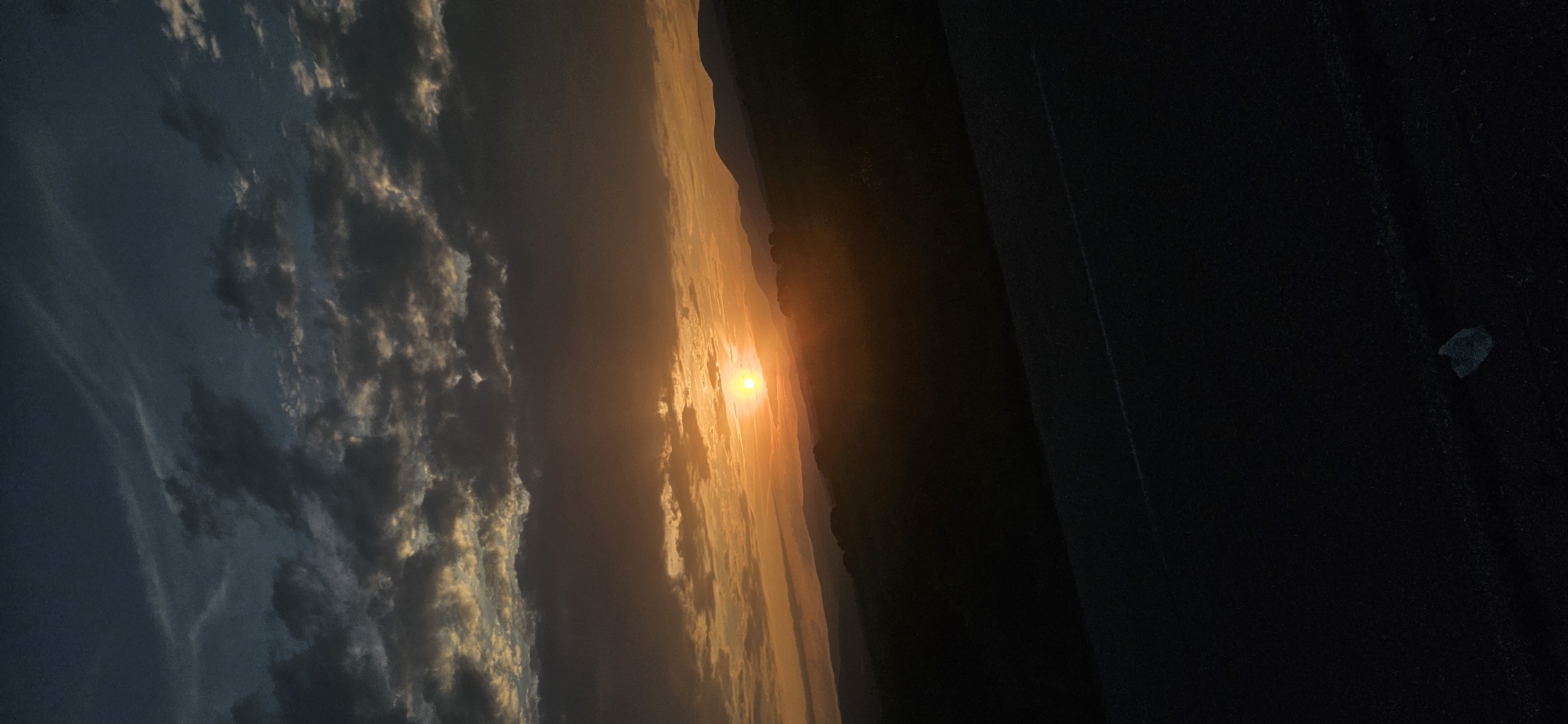Sunset observed across rural Bulgarian mountain pass landscape