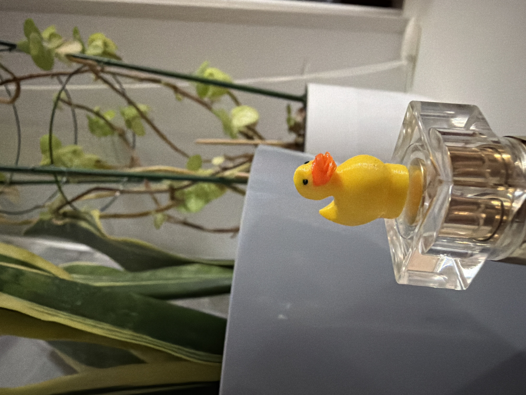 Yellow rubber duck photographed with glass bottles in Tujmazy