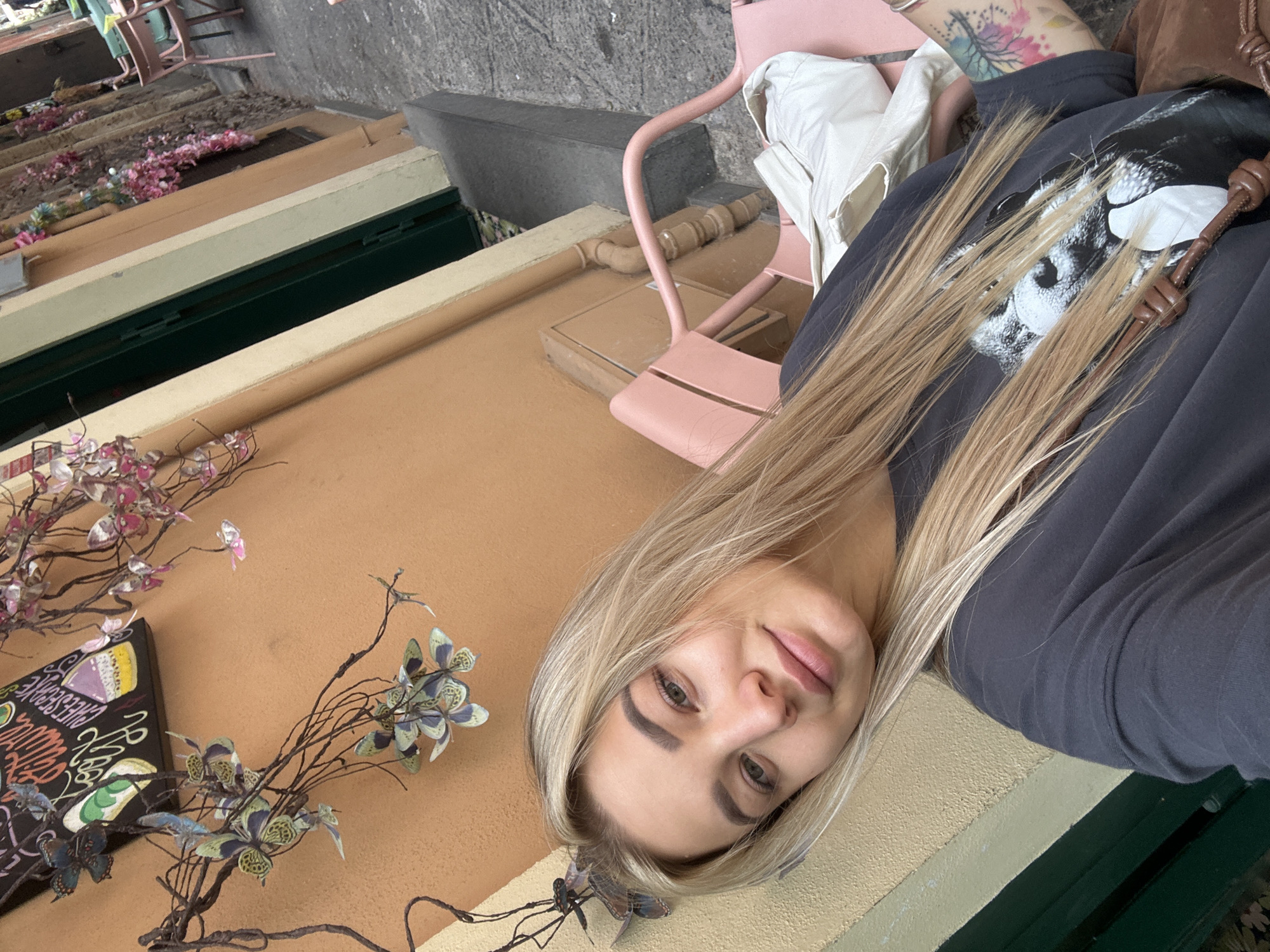 Woman captures selfie on flower-decorated Catania street