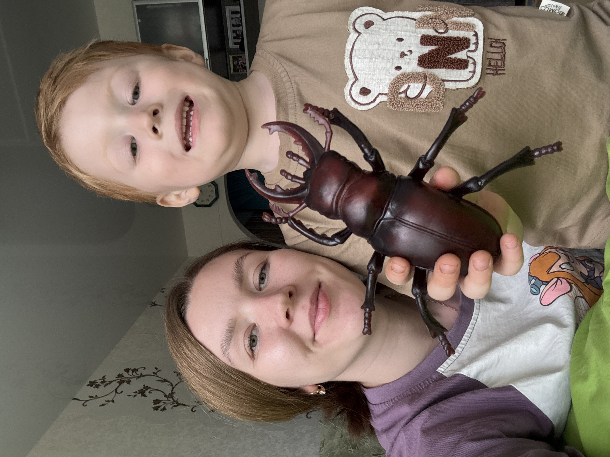 Woman, Boy Share Moment With Beetle Toy in Chaikovsky